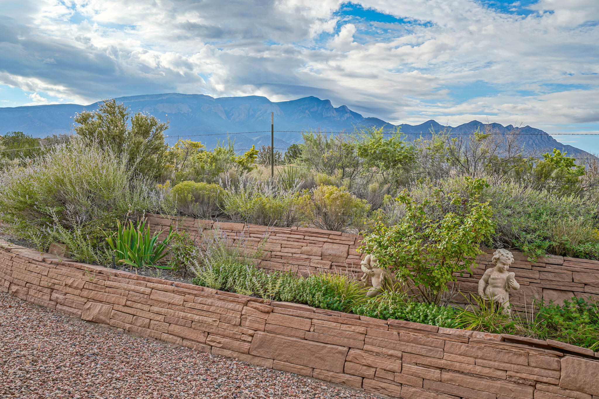 The Ultimate in luxury, Custom designed for the property to capture the huge unobstructed Sandia Views. Complete privacy abutting the Sandia Pueblo. Ultimate quiet, energy efficiency & secure feel with Straw Bale construction. The home was designed around a collection of Antique doors including Ziwan doors leading into the courtyard collected from all parts of NM. Handmade wooden cabinetry, antique vanities, stamped concrete flooring throughout & radiant heat to warm your toes. An architectural treasure. Standing in the generous entry hall fireplaces are mirrored at each end of the halls creating a visually pleasing reflection of each other. The sunroom windows open a large expanse bringing the outdoors inside. Each guest suite includes a kiva fireplace, private bath, & sitting area.
