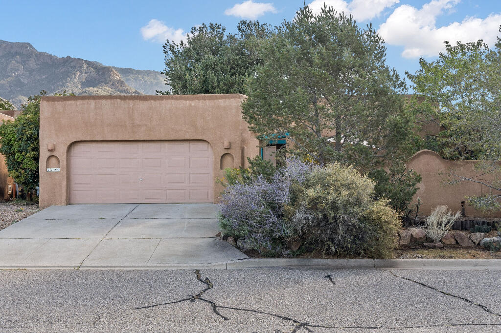 Updated and move-in ready, 2070 sq. ft., 3 bed 2 bath Cedar Canyon home, plus 150 sq. ft. office, in quiet cul-de-sac in Sandia Heights. Updated kitchen with new appliances including stovetop, oven, dishwasher, and garbage disposal. New Master Cooler, Roof is 5, Windows are 4. Screens are new. New leaf filters on gutters with warranty. New flooring in office. 5 more years of labor warranty on roof. New blinds. Antique oven from PA. will warm whole house and make bread. Master suite has kiva fireplace and large walk-in closet, 2 sink bathroom with tub and shower, new ceiling fan. Saltillo tile through common areas. Beams at top of high ceilings in living room and kitchen. Skylights throughout home. Living room has kiva fireplace and large bay windows. Recently, freshly painted garage door,