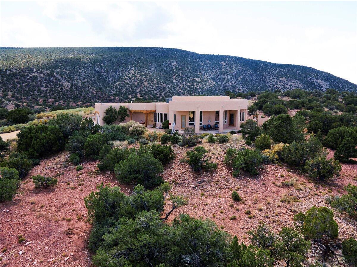Experience Magnificent Panoramic Views in a Private, Star-Studded High Desert Mountain Setting Designed By Architect Ron Montoya and Built by Lee Michael Homes. Stepping Through the Foyer, Breathtaking Large Open Spaces Include Custom Chef's Kitchen With Ample Storage, Work Space and Walk-In Pantry, Open Dining and Inviting Great Room Adorned with Pine Vaulted Ceilings. Oversized Master Walk in Her/His Closets and Separate Bathroom Vanities Compliment the Jetted Master Tub and Snail Master Shower. Two Dedicated Office Spaces, Radiant Floor Heat, 2 New HVAC, 2019 Roof, Water Heater, Excellent Well-Maintained Septic System, and Finished Oversized Garage With Work Space. Outside Grill Kitchen, Kiva Fireplace, Pond and Spiral Stairs to Roof with Sitting Area. LO/SO Gate Entry, Private Showin