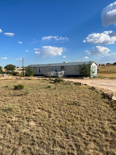 Affordable home on fenced and gated 2.5 acres with detached garage.  New furnace in 2019, hot water heater and swamp cooler in 2022.  Natural gas, shared well ($50 per month to owner of well property), front and back decks, nice roomy useable acreage on south side of house.  Horses and chickens welcome.