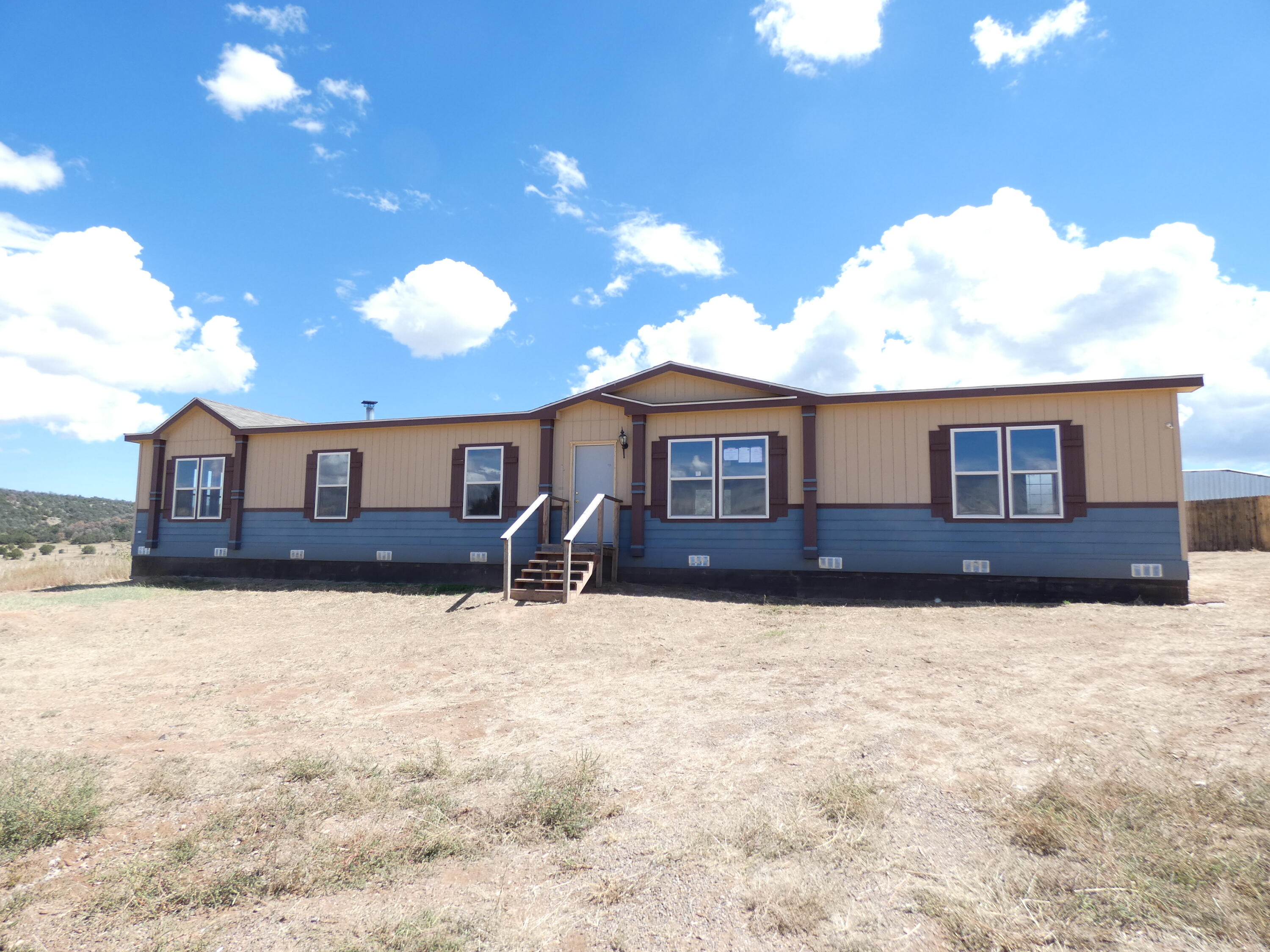 Spacious 4 bedroom, 2 bath manufactured home on 2.5 acres.  Close proximity to I-40. Home is eligible for $100 down payment program when using FHA 203 (b) or 203 (k) financing.