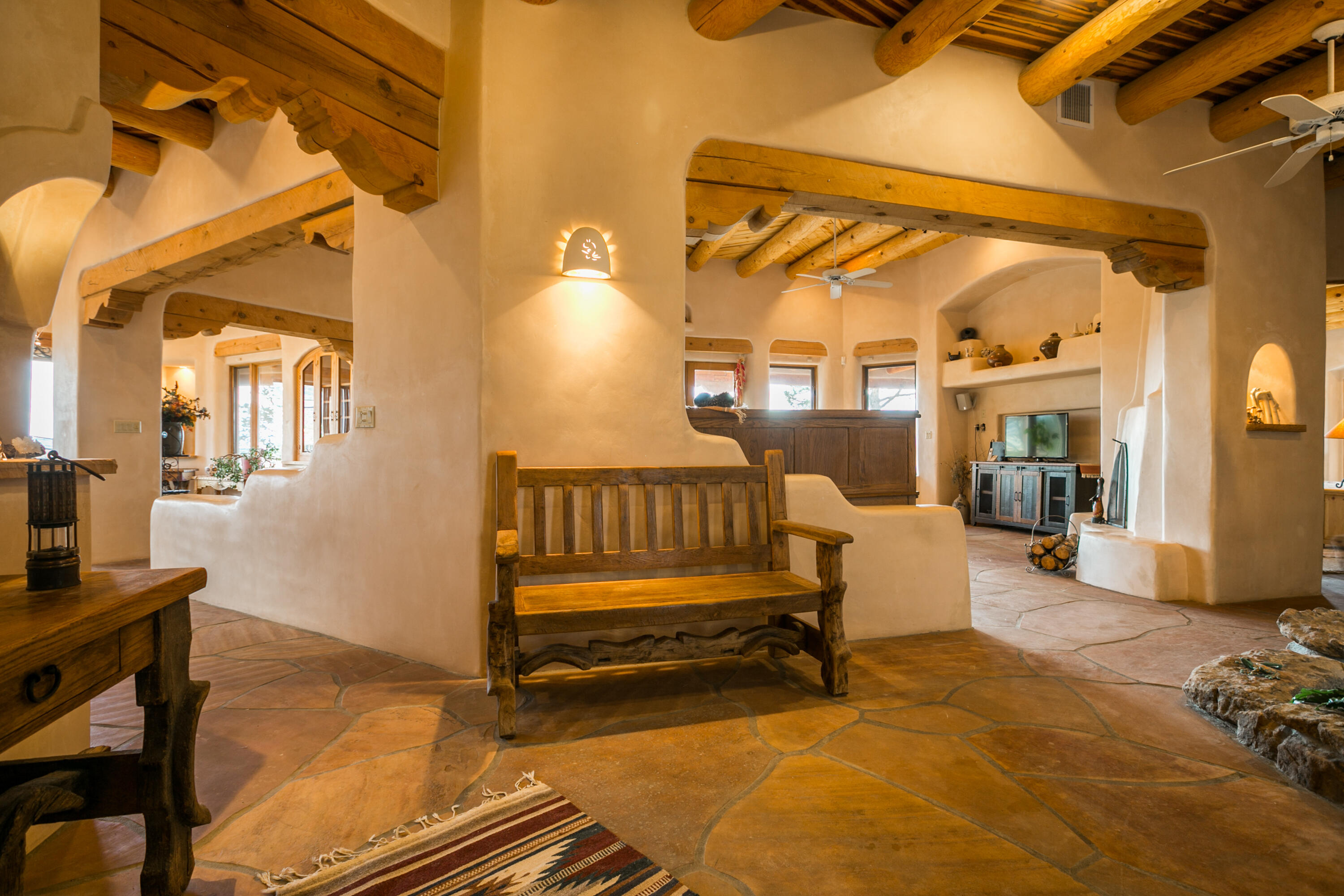 Rarely does a home of this Character, Quality and Comfort come to the market. This Enchanting and Stunning Santa Fe Style Home is your next dream location. Set in the foothills of the north Sandia Peak Mountains, this home is on just under 5 Acres with incredible views of Mountains, Mesas, Lights, Sunsets and Stargazing. Built as a handcrafted home with the Owner- Respected Builder Nick Garcia really shows his craftsmanship in this one. From the Front Door to the outside living spaces, your sense of place is a home with comfort everywhere. Wood Ceilings, Vigas, Plastered Walls, and incredibly gorgeous sandstone floors are yours to enjoy. The home flows freely from the gracious great room, with Fountain and Handcrafted Kiva Fireplace. Click the ''more'' tab from here.