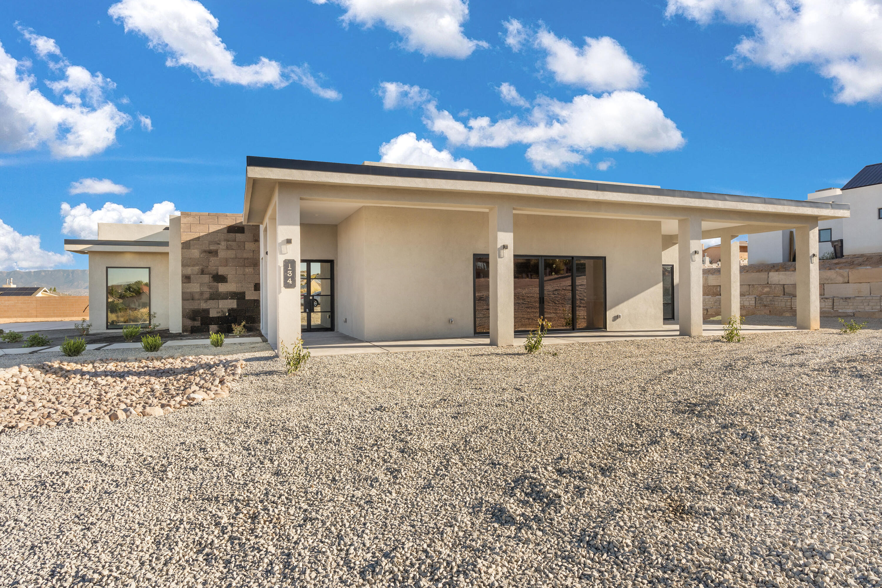 This Custom Contemporary Home is brought to you by First Impression Builders! Sitting on a half acre in a centralized Rio Rancho, this one is upgrade rich! Simple landscaping with backyard access, 3-car epoxied garage & roof top deck with untouchable views! Metal French doors leads you into this modernly-styled dreamy home w/ 12-foot ceilings in the living room and kitchen and your own boujee bar. Sleek tile flooring throughout helps create seamless vibe. Fall in love with the Primary Suite showcasing a walk out covered patio & en-suite loaded with ritzy upgrades such as black freestanding tub, walk in shower, double vanities, dual-closets..the list does on. Natural light floods the home with the extra large windows, sliding doors, and skylights. The eclectic gourmet kitchen touts solid