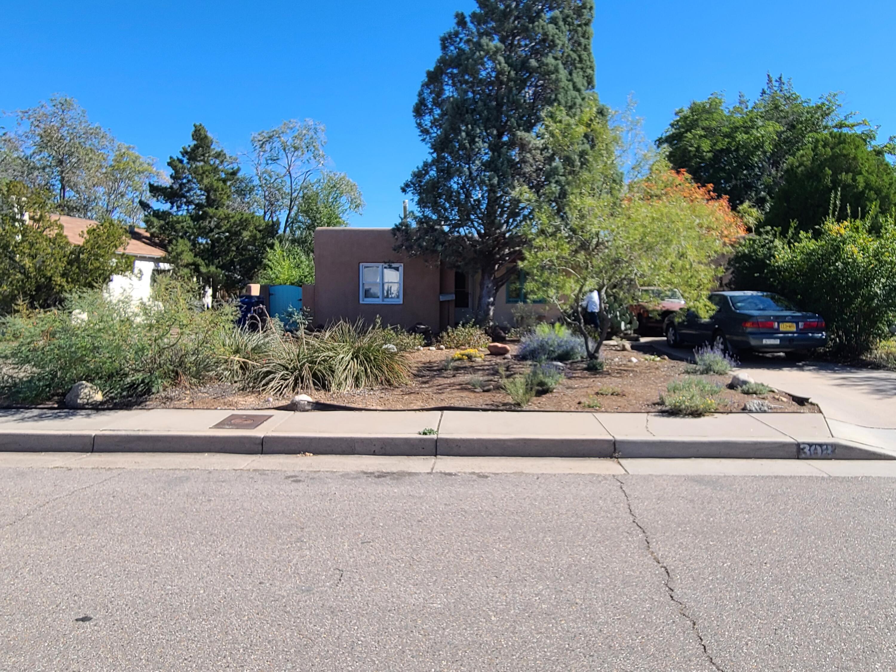 This UNM area 3 Bd./1.75 Ba. casa has 1600 plus sq ft of Southwestern charm and has been very well-maintained with upgraded plumbing and electric. (200 Amp) It is a partial adobe that has been thoughtfully added to with a 20 X 14 Master Bd. with 3/4 Ba. & a 19 X 15 family rm that egresses to an inviting xeriscaped backyard. Recently refinished original hardwood floors in front living room and bedrooms. Living room has beams, T & G ceilings & a custom W/B Kiva FP. Galley kitchen is tiled, has tons of cabinets and is flooded with natural light.  Natural SW landscaping in front and back. WOW! Hurry on this one. VLB       Thanks