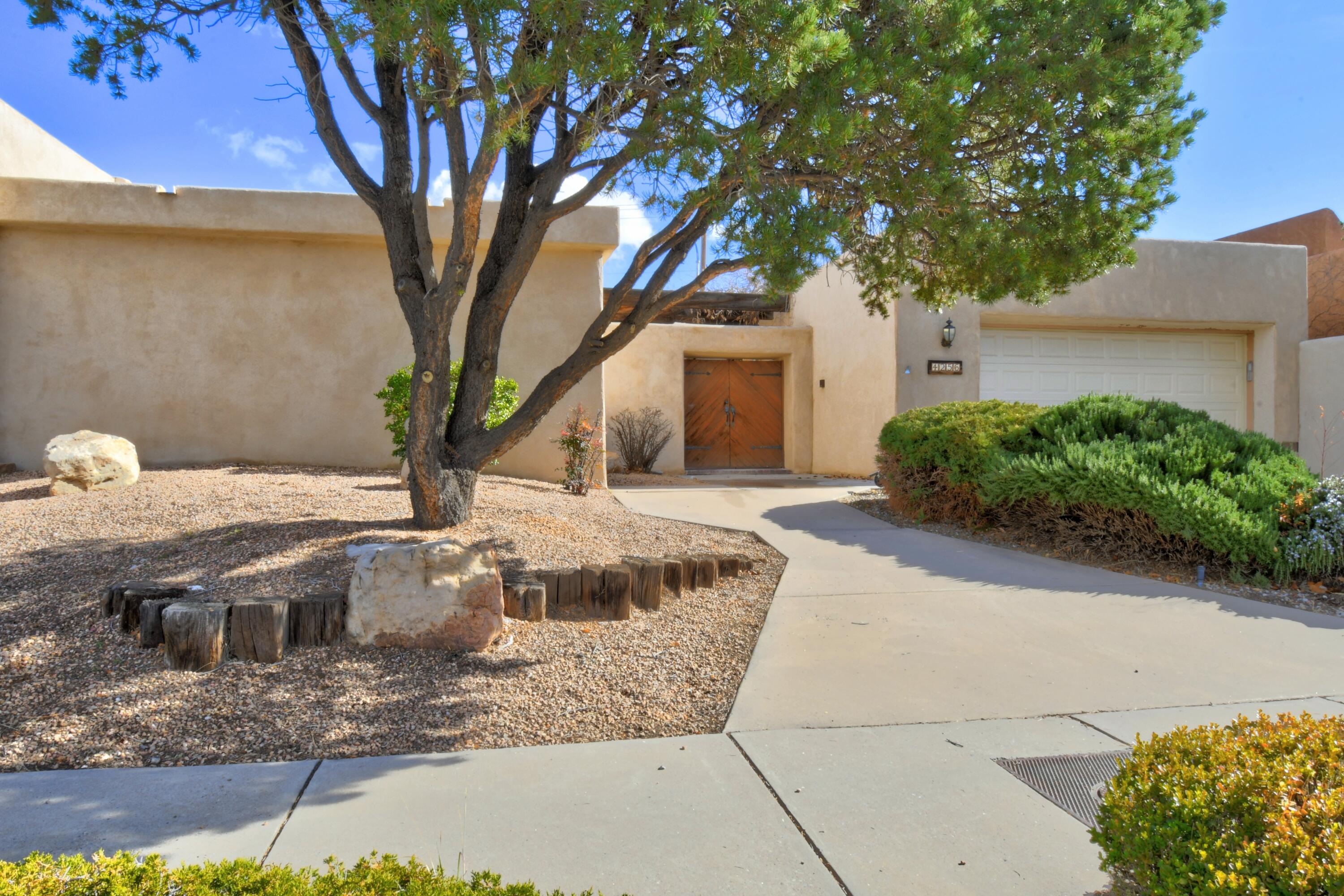 Fabulous single story town home featuring a private courtyard and wisteria covered patio.  The spacious great room, with high ceiling and exposed beams, opens to dining room, kitchen and sunny breakfast nook. The large primary suite includes a bonus room and a luxurious primary bath with custom shower/tub and double sinks. New carpet installed 11/22 and fresh paint throughout.  Landscaped front and back.