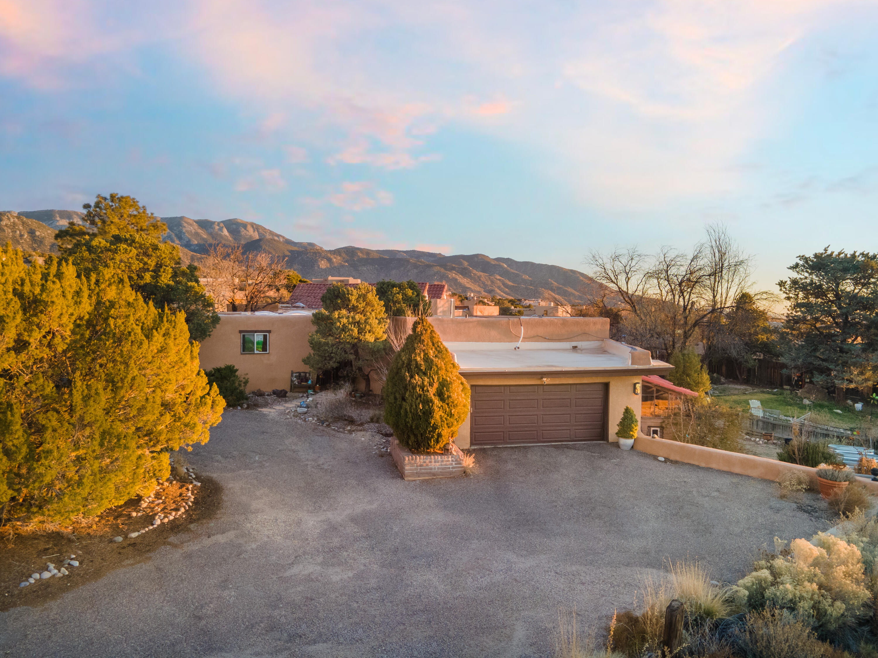 **OPEN HOUSE SAT 12-3:30pm**Situated on one of the best fenced in lots (.88 acres) in SANDIA HEIGHTS! Wonderful VIEWS of the Sandias. Single level 4 bdrm home that offers a beautiful great room w/tongue & groove beam ceiling, & cozy pellet stove fireplace. Opens to the circular formal dining room and gourmet kitchen with island. The primary suite showcases the incredible mountain VIEWS with its own private courtyard. Nice sized secondary bedrooms. Enclosed 1,800+ sqft pool/recreational room (not included with sqft) needs TLC. Outside porch with banco and fireplace.  Refrigerated air. Backyard with an area for a vegetable garden. 2 Car garage with work bench. **SELLERS WANT TO SELL IN ''AS IS'' CONDITION.** PRICE REFLECTS CONDITION.