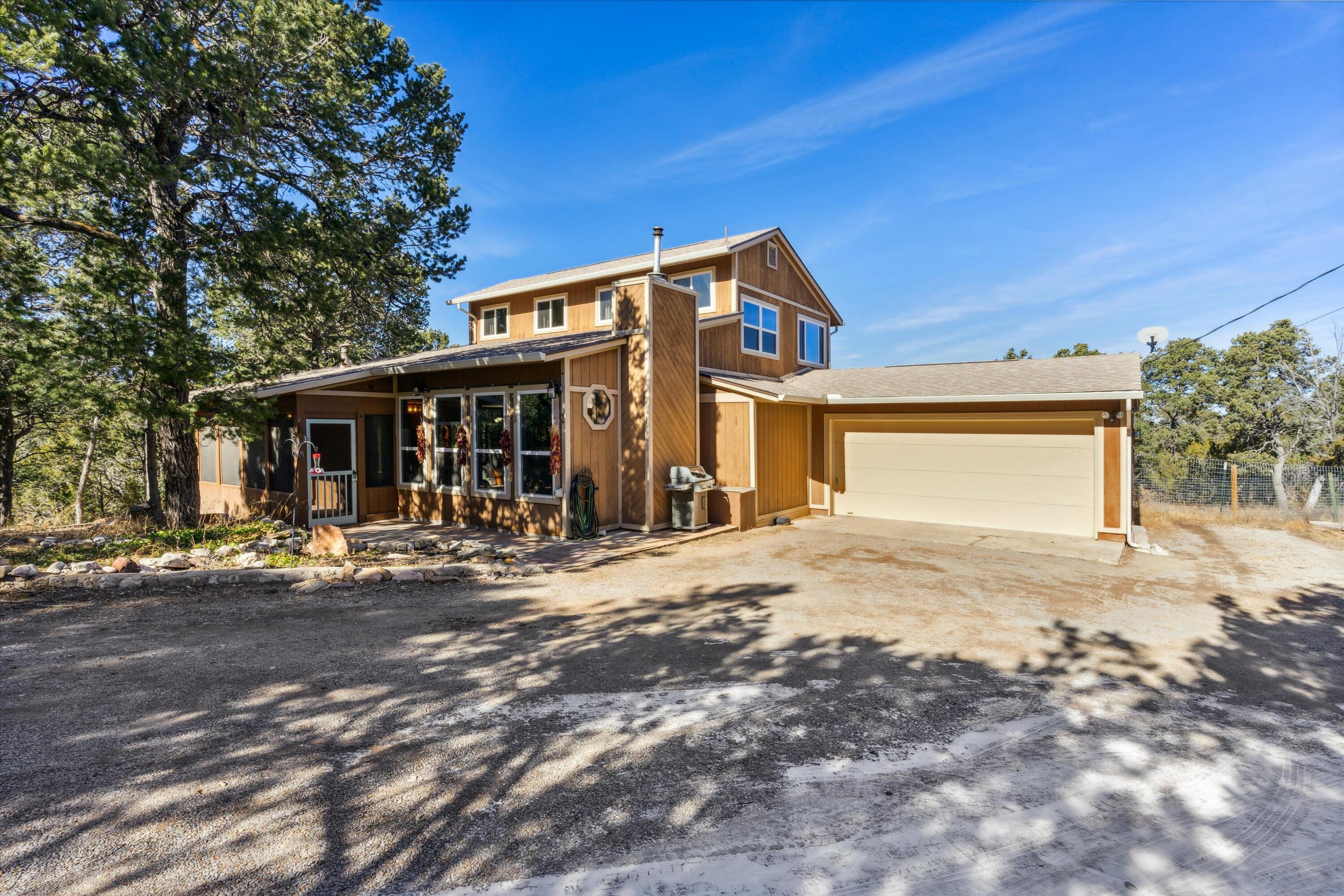 Welcome to this charming mountain retreat in Tijeras. This home features numerous updates including a new roof in 2019, remodeled bathrooms, new vinyl windows and a newer pellet stove.  Other features include brick floors, wood ceilings, and a wonderful open floor plan.  Relax on the front porch, or the master bedroom deck.  Large shed is perfect for all the extra things you need to store.  This home has been well cared for and is super clean, come see it today!