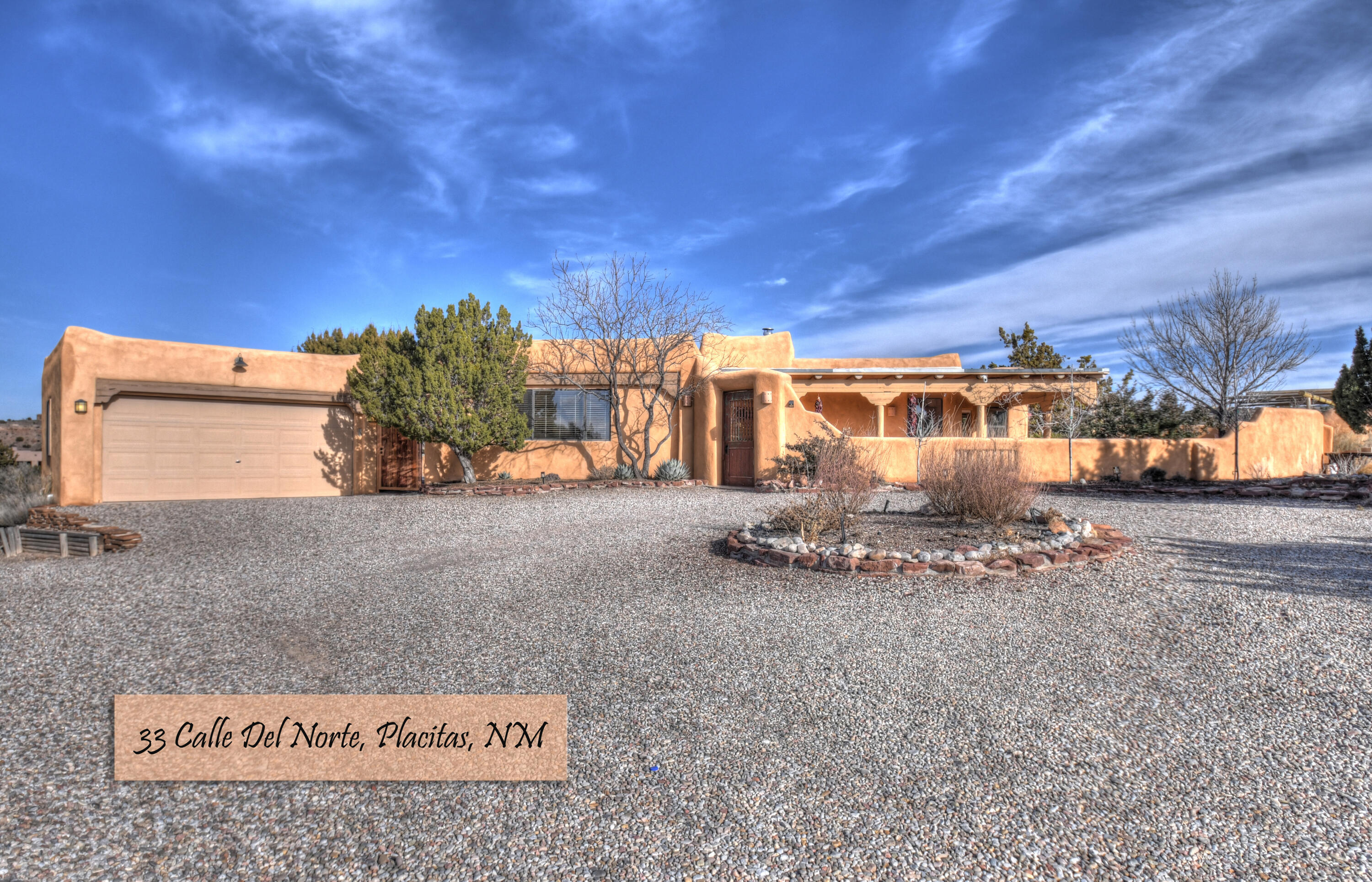 This stunning luxury southwestern home takes advantage of the incredible vistas afforded from this private and beautiful homesite.  This home is a 2 possible 3 bedroom with a 2 bedroom guest house.  The views are captivating.  Relax poolside in your private lap pool overlooking the dramatic landscape that includes two coy ponds as well as two covered patios including an outside Kiva fireplace. This single story floor plan offers a butlers pantry with a sub-zero wine cooler.  The laundry room also includes a workspace for your hobbies.  There is a mud room at the back entry.  28 owned solar panels provide  energy, making it almost totally off-the-grid.  Enjoy the dramatic night skies, beautiful sunsets and incredible views of the high desert landscape from this great home.