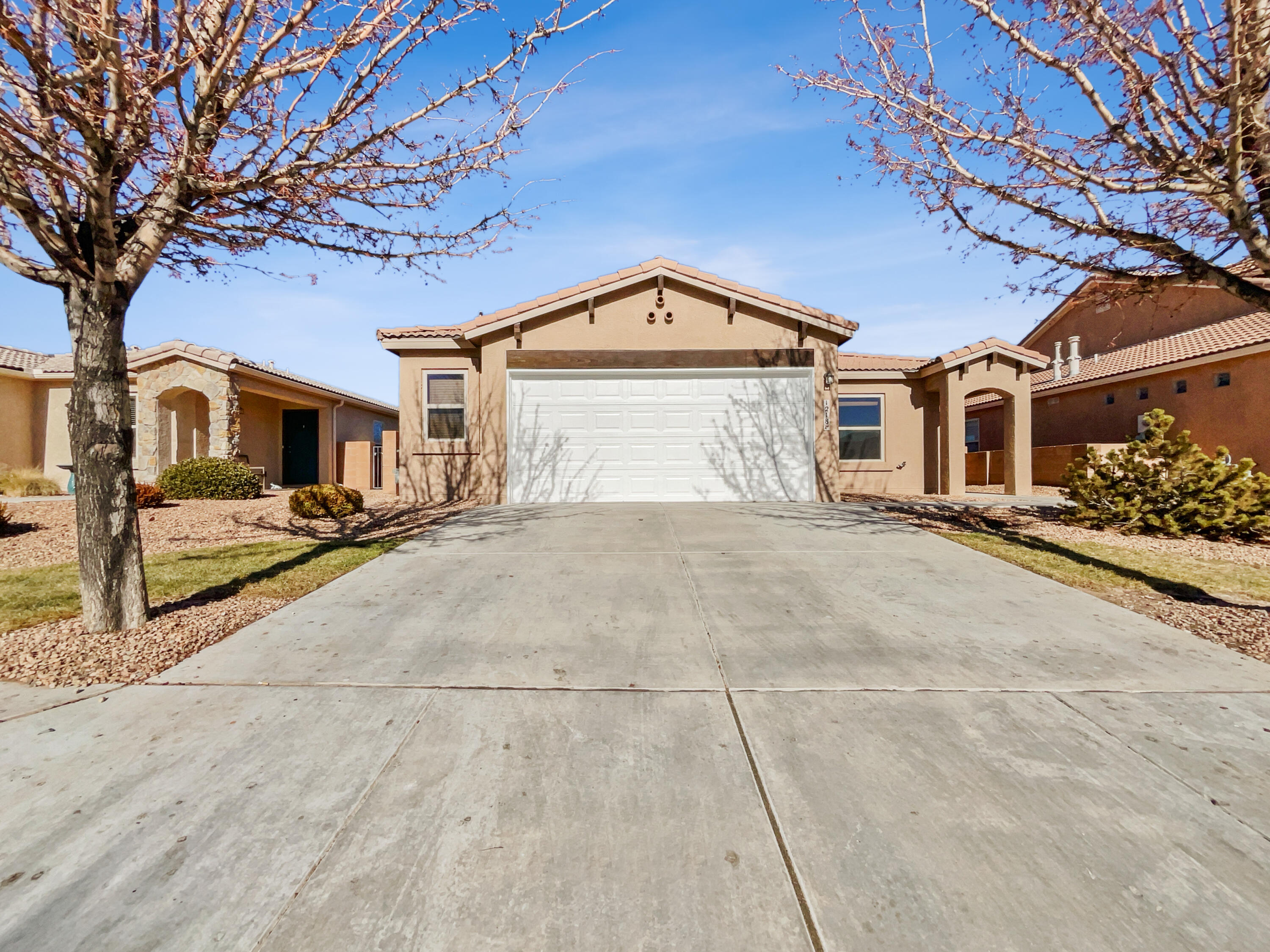 This Bernalillo one-story home offers a patio, granite countertops, and a two-car garage.