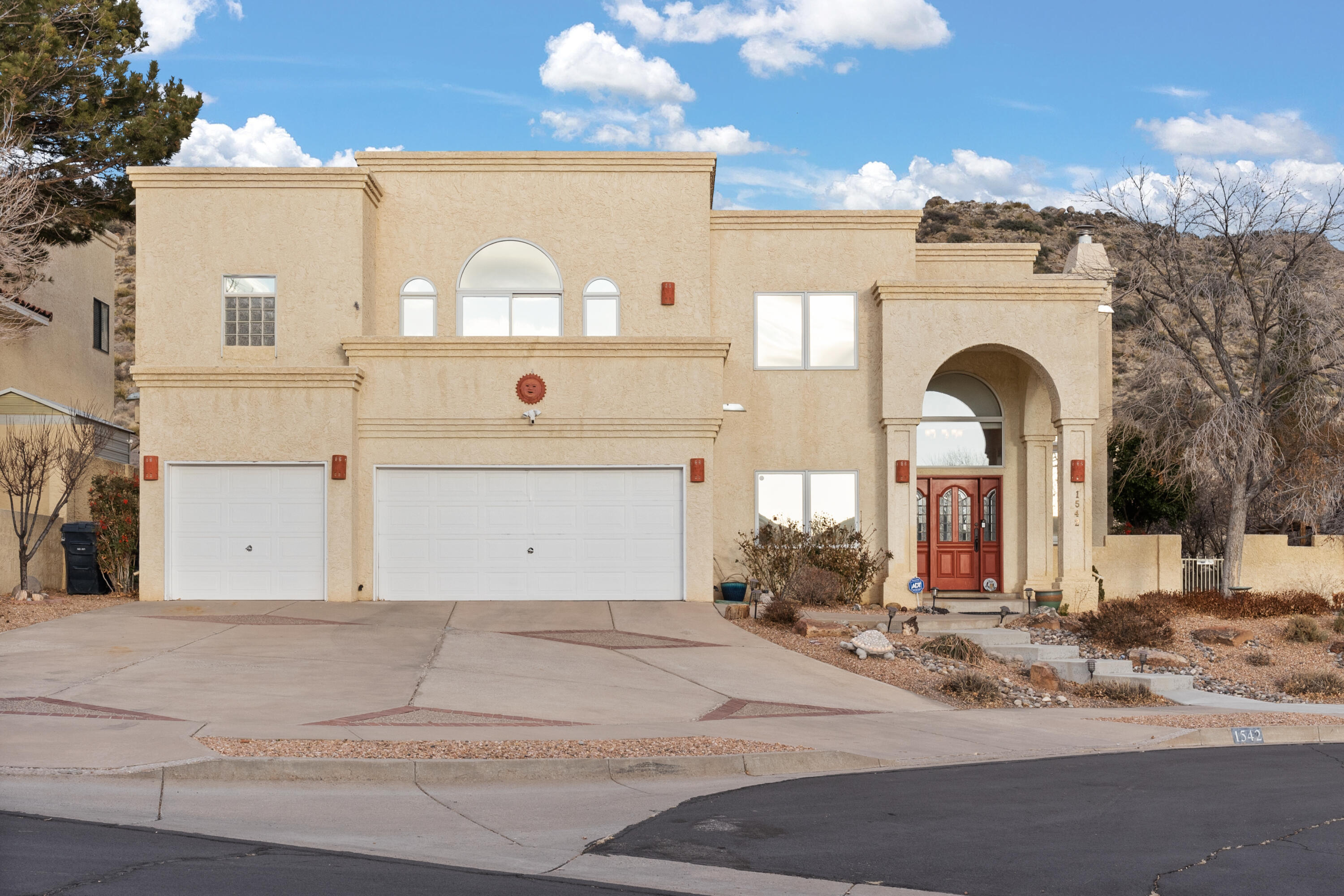 Nestled in the foothills, backing to open space, this beautiful 4BDR/3 FULL BATH/3CG has incredible views of the Sandia Mtns! One bdr/bath or office/exercise room on the main level! Two living areas w/cozy gas fireplaces, formal dining, soaring ceilings, walls of windows, skylights, & balconies w/incredible views!  Entertainer's kitchen w/granite countertops, island/bar, pantry, gas cooktop, built -in wall oven & wine rack. Master suite features a balcony, walk-in closet, jetted tub, sep shower & separate office/study! Stargaze in the hot tub, enjoy your morning coffee with the sunrise, relax in the evenings w/ tranquil sunsets, entertain family & friends in this amazing outdoor living space with open patio, rose bushes, honeysuckle, fig & ash trees, easy care turf!  Explore nature trai