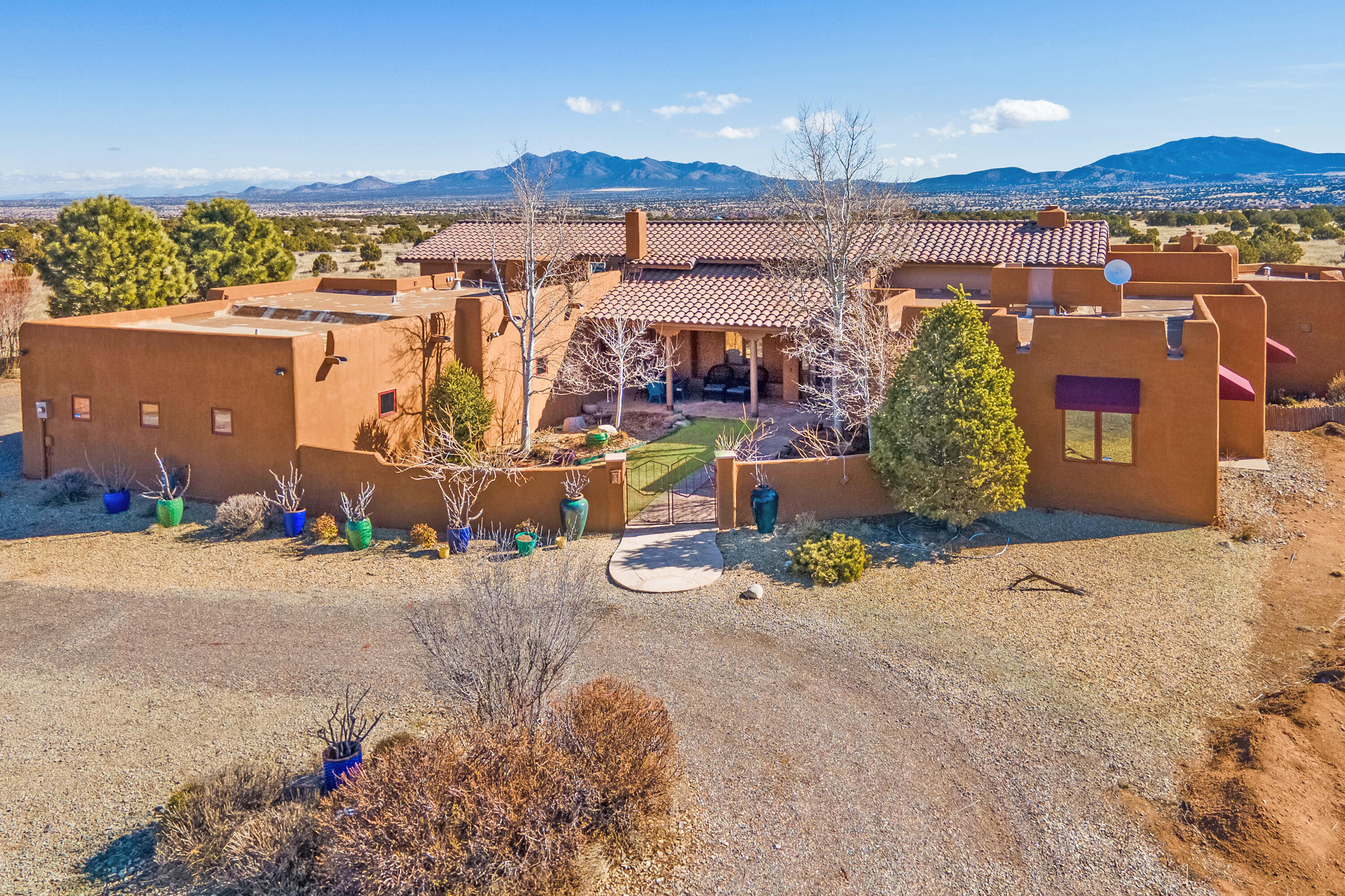 Welcome to this Custom, Single-Story Spanish-Style East Mountain Estate built by Premier, Award-Winning, Luxury Home Builder, Engelman Construction. Nestled on 10.23 Expansive, Easily-Maintained Private Acres, 32 Punta Linda presents you with Awe-Inspiring, Panoramic, 360-Degree Views of Multiple Mountain Ranges from the Comfort of Your own Personal Sanctuary. The Heart of this Home is its Top-Tier, Gourmet Kitchen complete w/ Island, Alder Wood Cabinetry, Wolf Gas Cooktop, Warming Drawer, Oven, Convection Microwave, Subzero Refrigerator. Vaulted, Timber-Laden Ceilings create a Dramatic Impact and add to the Wow-Factor of this Extraordinary Home. Living Spaces open up to your Covered Portal and Courtyard, both equipped w/ Toasty Outdoor Fireplaces, ensuring Indoor-Outdoor Living with Ease.