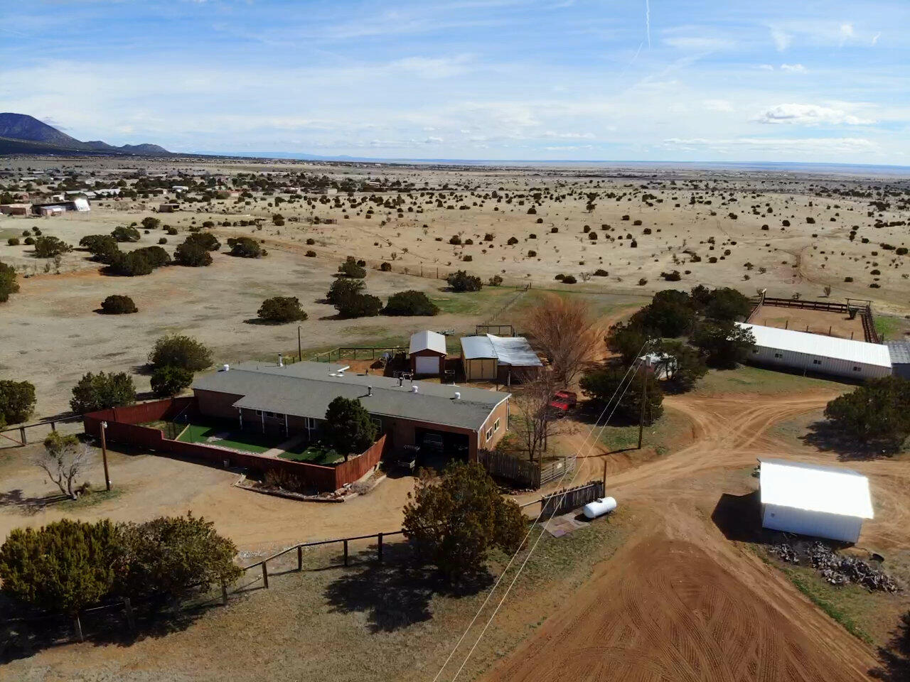 Attention! Dog Enthusiasts- Trainers, Breeders, Show Exhibitors or Horse Equestrians, Hobbyist, Trainers LOOK at What this Property Has to Offer!  A Property Like This does not come available very often! The Inside Kennel is Heated/Cooled, equipped with a Dog wash tub. Outside Kennel has 6 5X10 and 1 10X10. (Concrete & Heavy Rubber Matting & Metal Cover) For the Equestrian there is a 24X62 Metal Barn, Large Corral, small 120X80 arena and Large Lighted 120X260 Arena with Judges Stand. This property is perfect for Horse or Dog Events! Beautifully Maintained Country Home featuring 3 bedrooms, plus study, open floor plan, Yodel Wood Stove, Wood Laminate Floors, 8''Walls, 2 car attached garage. Beautiful kitchen with Knotty Maple Cabinets, Stainless Appliances and large Island. 14X28 Workshop.