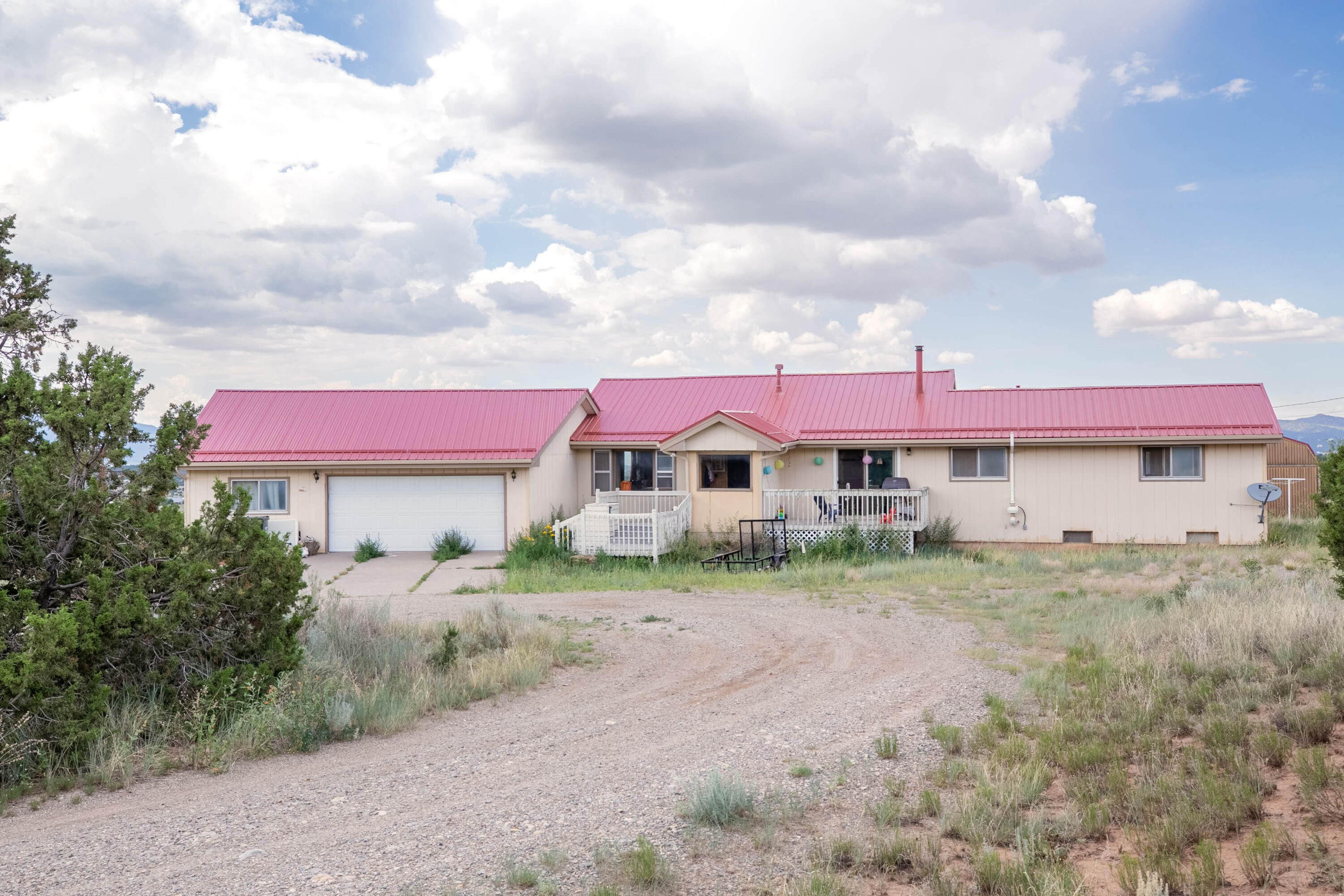 Enjoy the quiet of the mountains with views and private space of 4 acres. Metal roof and newer septic system. Lots of updates including wood floors, open kitchen, tongue and groove raised ceilings, master bedroom on main floor, wood stove, finished basement with separate bedrooms and second living area, and storage or home office. Oversized finished 2 car garage with workshop. 4 Fenced acres with woodshed and barn.