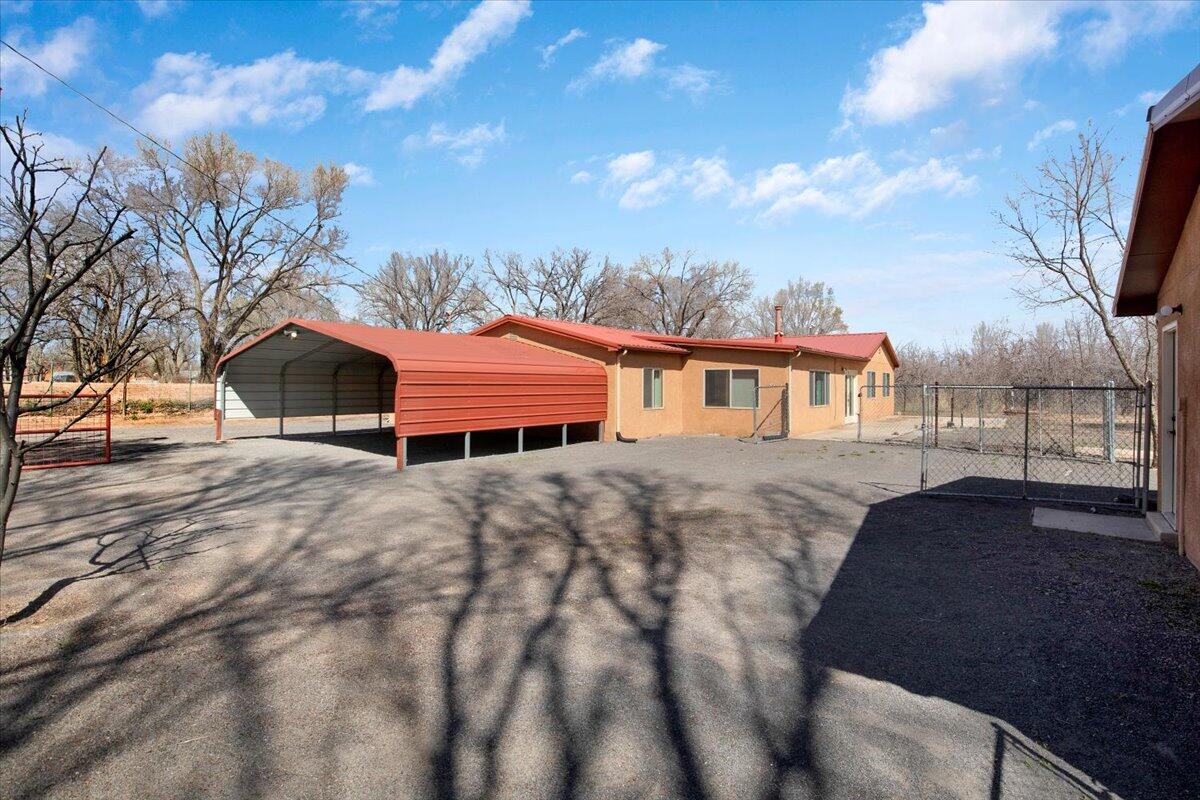 Proudly presenting 1311 Fuji Lane! This all custom Bosque Farms home sits on 3 desirable acres tucked away on a charming little lane with only 2 other homes on the street! Private, quiet, and with irrigation, this property also offers a huge apple orchard! Whether you are already a farmer, or just want to become one, several varieties of apples and mature, but young, trees are ready for you to step in and live the country life! The home is a blend of SW custom and simple elegance with pine doors, cabinets, vigas, and large tile flooring throughout. The wide open floorpan is bright, light and a great use of space. Living, dining, and expansive kitchen allows for ease of entertain and gathering. The kitchen has a huge center island, gas cooktop, and loads of cabinet space. Both bedrooms are