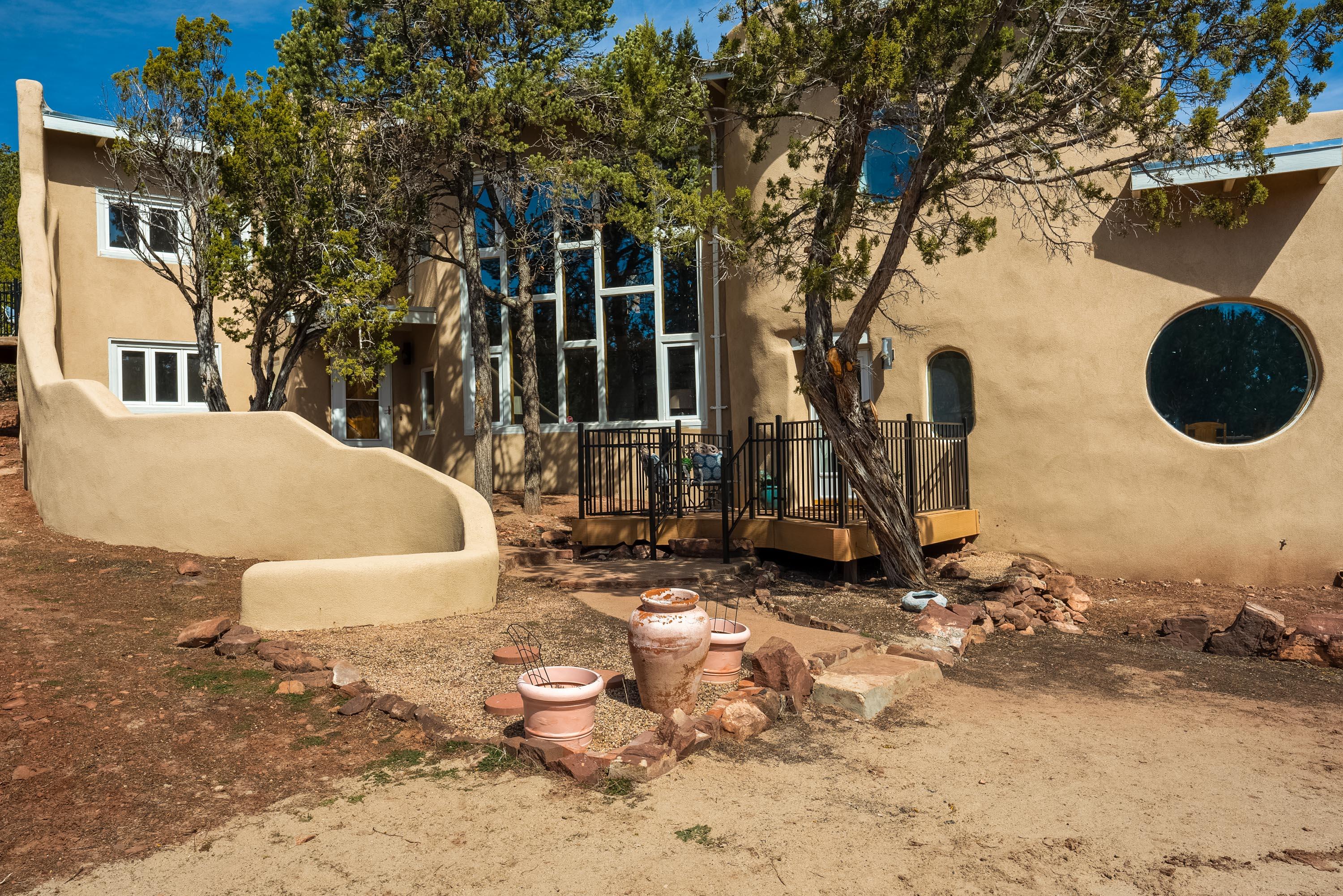 Stunning Custom Adobe/ Frame home on 2 acres in the Eagle Crest Estates gated community. A short 16 minute drive from Kirtland AFB, but the feeling of seclusion.  Hand carved beams and corbels with a beautiful wood staircase. There are mini-splits in all the bedrooms and main floor, stainless steel appliances and completely remodeled kitchen and bathrooms. Quartz countertops throughout. Central Vacuum. Come and enjoy the mountains!  New septic system 2023 and currently on stored water, new well to be installed before May 1. New Roof 2022.