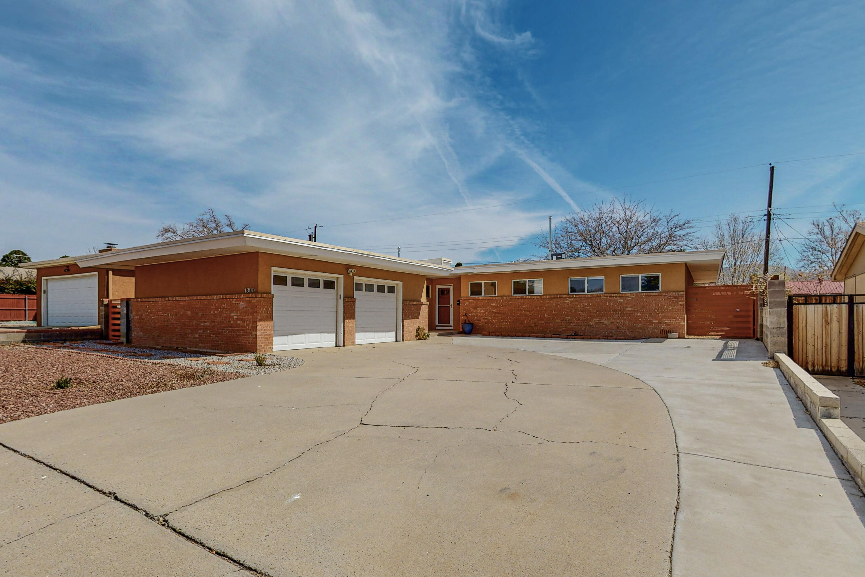 Run, Don't Walk, to see this Meticulously Updated, Improved and Maintained ''Mid-Century Modern'' Home. The Beauty, Functionality and Design make this home a true MUST SEE. Modern Iron Gates to match the Home's Design and Colors, Hardwood floors, TPO roof, New Refrigerated A/C/Furnace, Replaced cast iron plumbing to PVC, Fresh Paint, New Appliances... A truly delightful home with RV Parking. Schedule you're showing today!