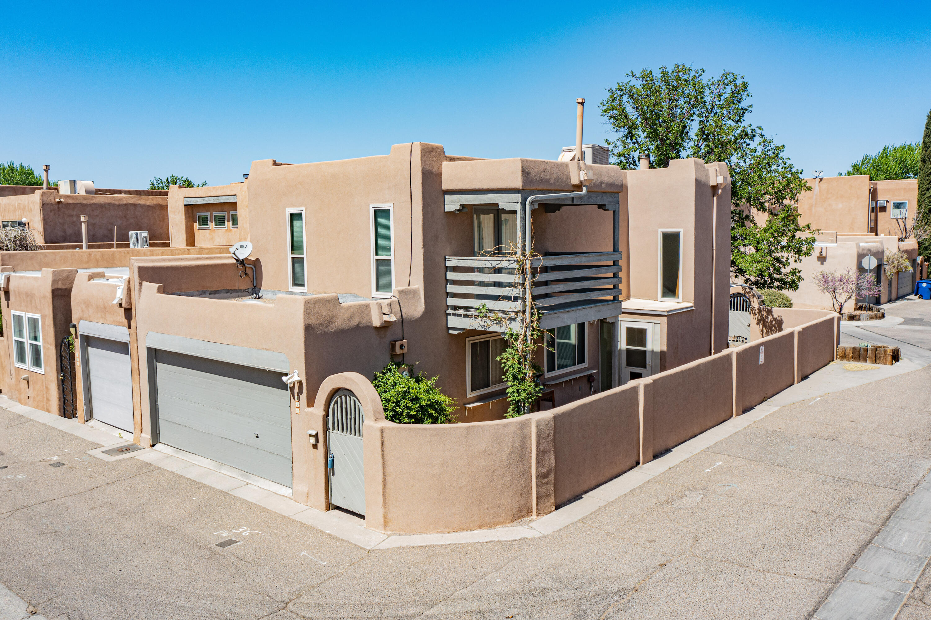 Located off Rio Grande Blvd in Old Town you will find the Pueblo del Norte Community. Downtown & the exciting Sawmill District nearby! Miles of bike & hiking trails along the Rio Grande Bosque are just around the corner.  You will also find museums, galleries, some of ABQ's best dining, shopping & recreation just steps from your front door!  A private courtyard entry will welcome you home to this lovely townhome featuring 2 bedrooms plus office, 2.5 bathrooms, & attached garage w/workshop space. The open kitchen has granite counter-tops & is perfect for entertaining; all appliances stay! Cozy fireplace in the living room & french doors open to your private side yard. Up the stairs are built-in bookshelves. Primary Suite has a view deck!