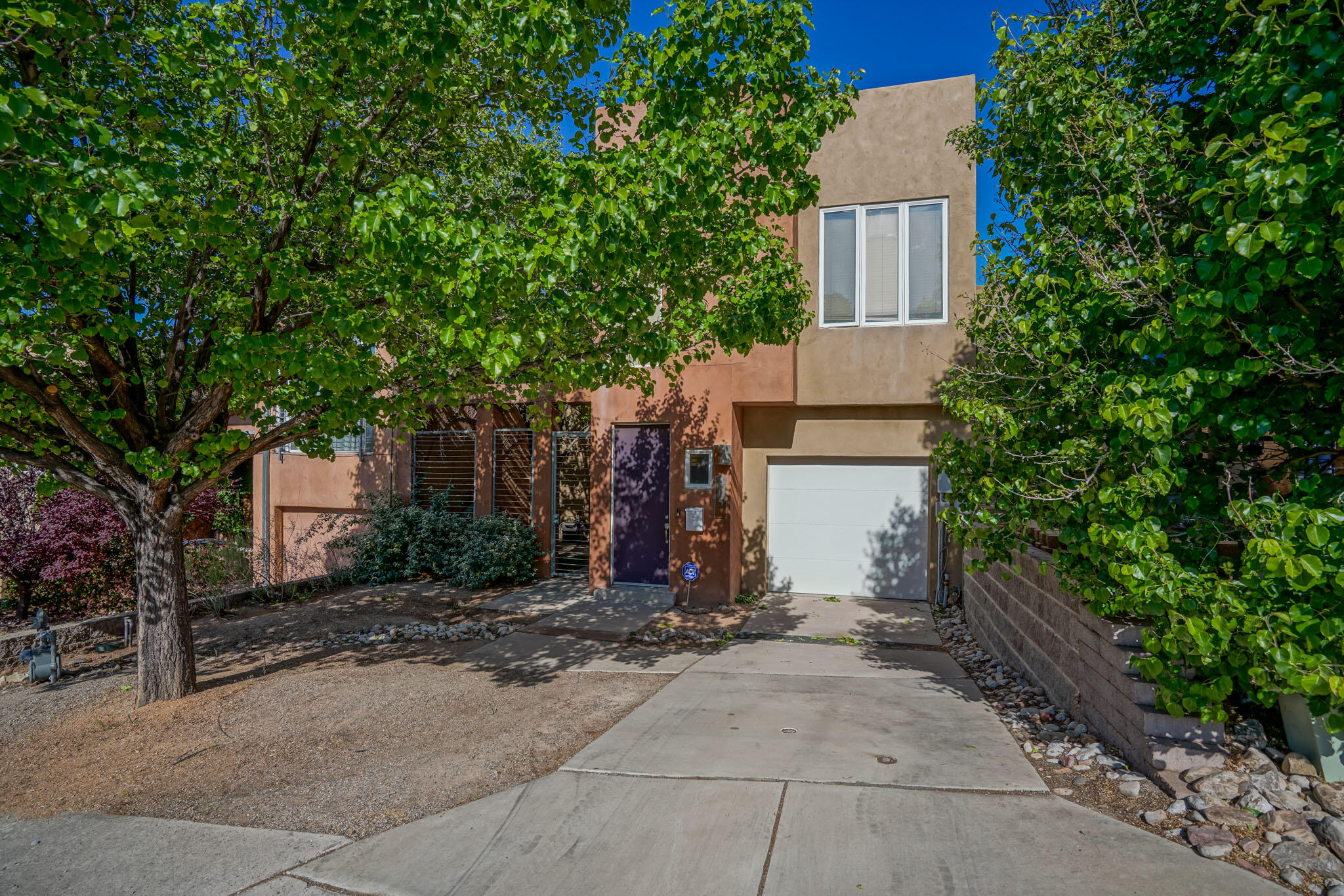 Gorgeous Spruce Park townhouse! Don't miss this one. These units don't come up very often. This home features concrete floors down stairs and bamboo upstairs with both levels offering radiant heating. Refrigerated air for cooling. As you enter you will immedietly notice the incredible amount of natural lighting. The Two large bedrooms downstairs offer a private courtyard, large bathroom with double sinks and laundry. Climb up the stairs and step into a gorgeous kitchen featuring a gas fireplace and dining area, tons of large windows and the master sweet! The master offers a huge bathroom, walk-in shower, closet and a wrap around deck with city views! The fruitless pear trees and well manicured terraced backyard are all watered via drip irrigation. Close proximity to UNM,UNMH,and Nob Hill.