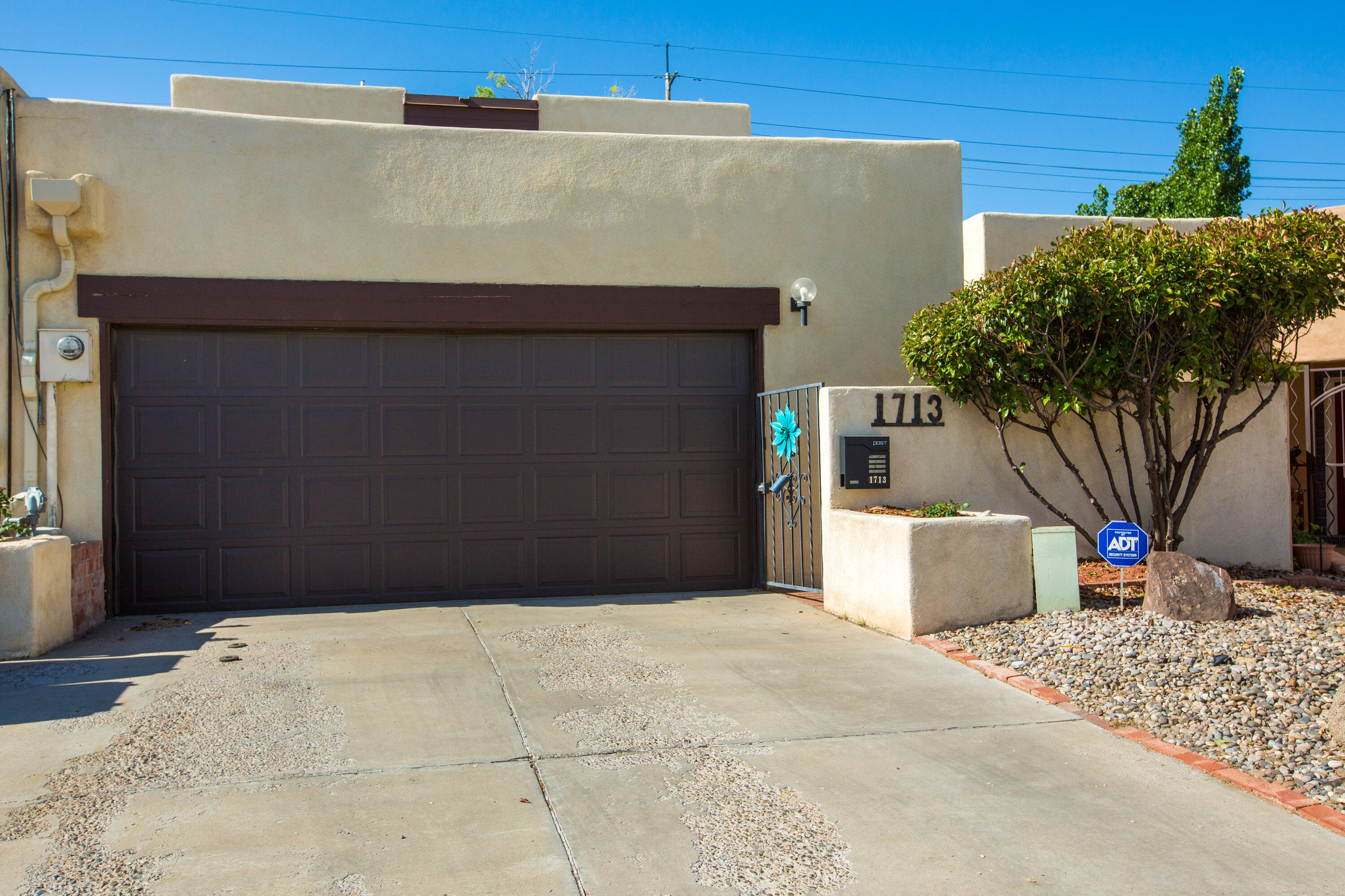 This incredible townhome is located in the highly desirable north UNM area and is convenient to the I40 corridor, UNM parks, restaurants, shopping and the new Whole Foods complex at Indian School/Carlisle. The home has been thoughtfully updated throughout, including a kitchen refresh with s/s appliances, granite counters, glass tile backsplash and freshly painted cabinetry. Spacious living/dining area w/ newly updated fireplace, mantle and wet bar. The primary bedroom features a sitting/office area, en suite bath with soft close barn doors, walk in closet and deck with beautiful views. Smart home features throughout! Enjoy the newly landscaped backyard from the covered patio. Two car attached garage has a large  heated/cooled storage room and workshop area with a sink. Welcome home!