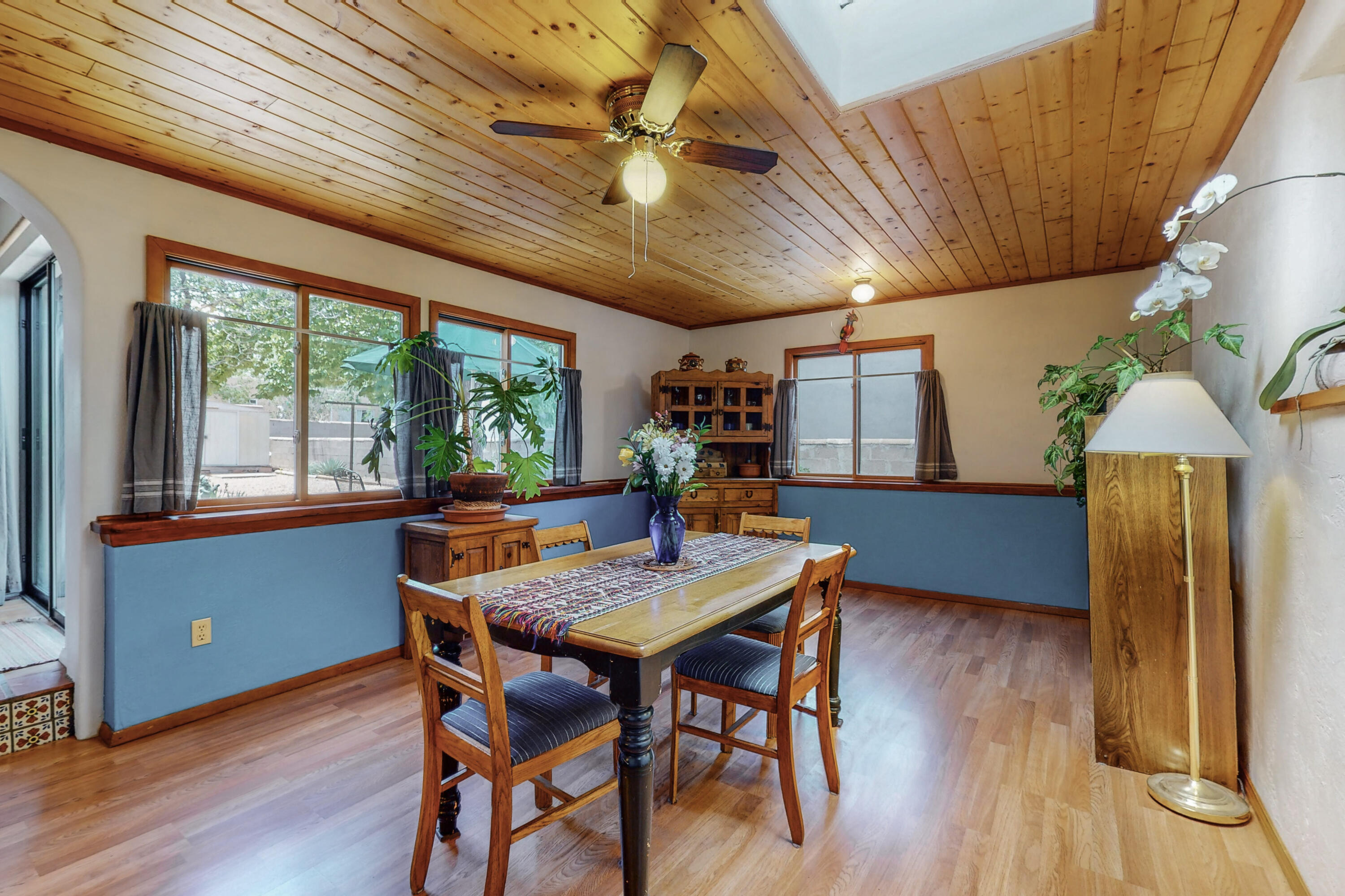 Charming, sunlit home in Ridgecrest Addn w/classic coved ceilings, gleaming hardwood, Saltillo, & tile floors, arched doorways, Talavera accents, double pane windows, upstairs loft, family rm or music room a great place for a good book & a nap on a sunny winter day! Expansive Owner's suite w/a fabulous bath, dual sinks & showers, jetted tub, walk-in closet. Roomy dining room with T&G wood ceilings, big windows overlooking patio & room for a cozy seating area! Not a typical converted garage, it's a perfect office or studio, light & bright, has a 1/2 bath, brick floors & window boasting a mountain view! Lovely kitchen w/solid countertops, pass through & fridge. Spacious lot w/shade trees, shrubs, patio space & deck! New roof, stucco & a list of updates, hurry this could be your ABQ Dream Home!