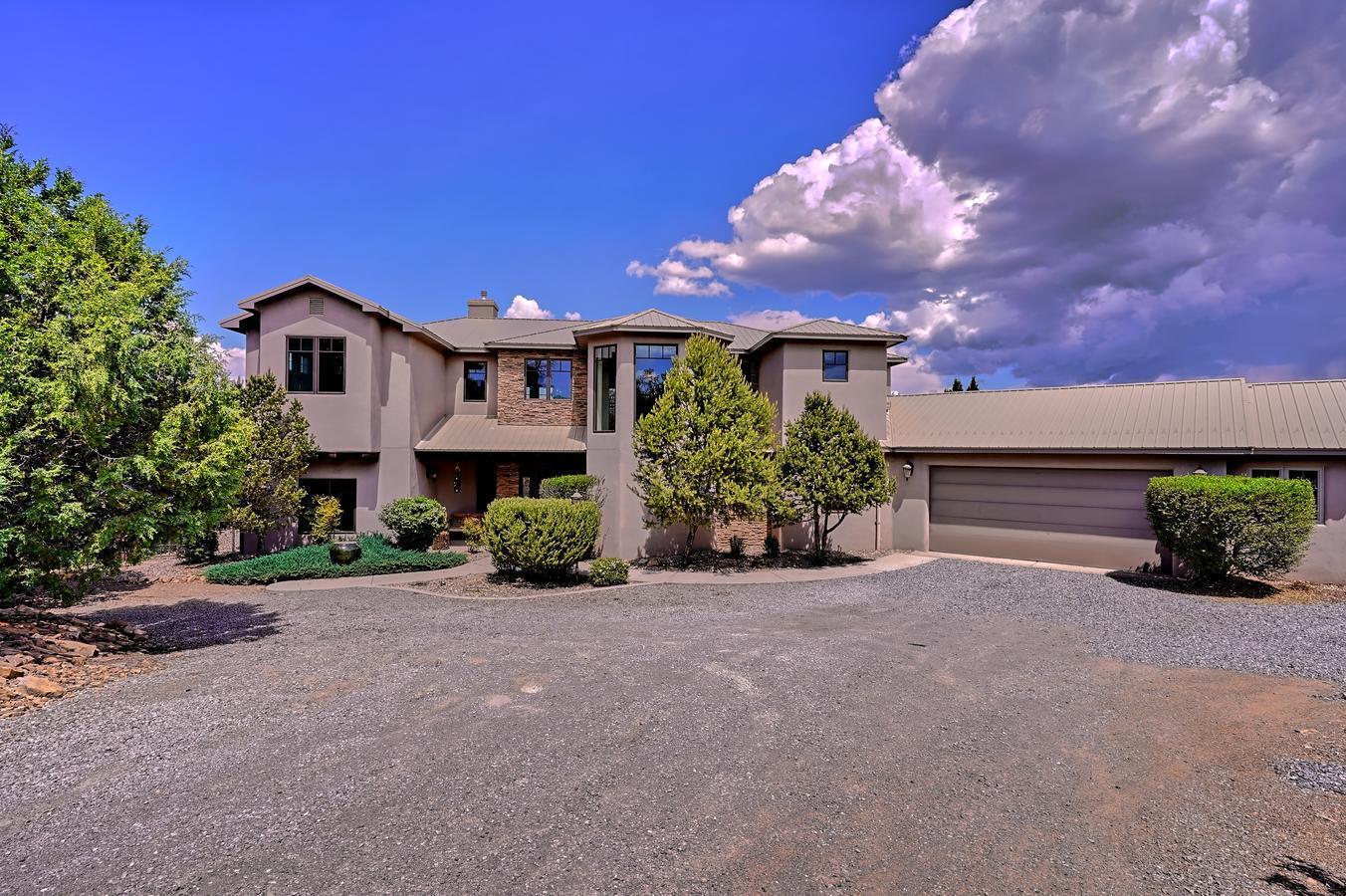Gorgeous Custom Home Nestled on a Wooded Private Homesite in Desirable Rancho Verde!  Stunning Great Room boasts Soaring 2 Level ceilings and Dramatic Fireplace to Relax by! Chef's Gourmet French Country Kitchen is an Entertainers Dream!  Abundant granite counters and  beautiful cabinetry! Huge Island is perfect for hosting gatherings. Elegant Dining area! Luxurious Owner's Suite offers a Resort Style Spa Bathroom for Ultimate Relaxation!  3 Bedroom's upper level, and a Main Level Bedroom and bath!   Phenomenal Mountain Views! Enjoy the NM Sunshine from your Fabulous Outdoor Living Space!  Close to the National Forest for Hiking, Biking! Ideal for Abq or Santa Fe commute! Live the  Dream of a Rural Lifestyle Amongst the Whispering Pines, yet close to City Amenities!