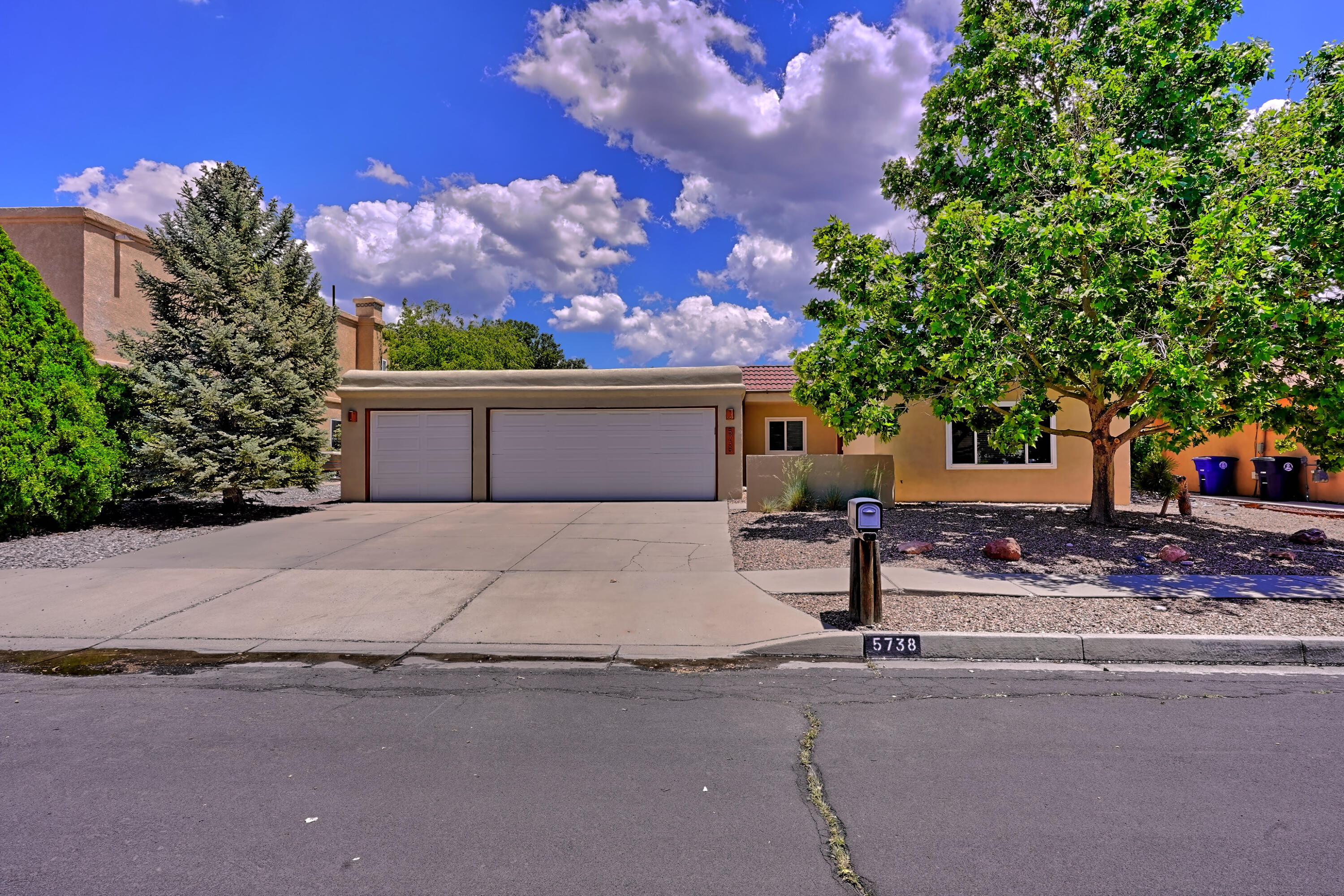 You have waited a long time for this one to hit the market. A single story, 4 bedroom, 3 car garage home in an amazing neighborhood is the gem you won't want to miss. This home is remarkable because it has so many fantastic upgrades. All electric is less than $10.00/mo with fully owned solar. Come see the Remodeled kitchen and bathrooms with beautiful cabinetry. Two living spaces and a NM classic kiva style wood burning fireplace is just the beginning of the amenities in this home. Newer windows, newer stucco, and an oversized garage make it easy to move right in this summer. Step right out to the lovely back yard for a BBQ under the covered patio. Garden space, play space and fruit trees grace the inviting outdoor living all year long. Call and make your appointment today.