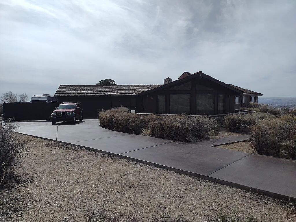 A unique ranch style home in Sandia Heights on a lot with 360 degree views. The house is multilevel with a walkout basement. The basement is a recreational area with over 1000 sq. ft. and a wet bar. There is plenty of  room for gathering and games and a separate space for a pool table. New carpeting, a new ceiling and new heating were recently installed.  A rock wall and brick decking are being added to the large patio outside. On the main floor, the large living room faces the mountains and has a vaulted ceiling and floor to ceiling windows that offer unobstructed views of the Crest and the Tram from bottom to top. The patio outside has even better views, morning sun, afternoon shade, a new rock wall and brick decking. It's a great place to see why the mountains are called the Sandias.