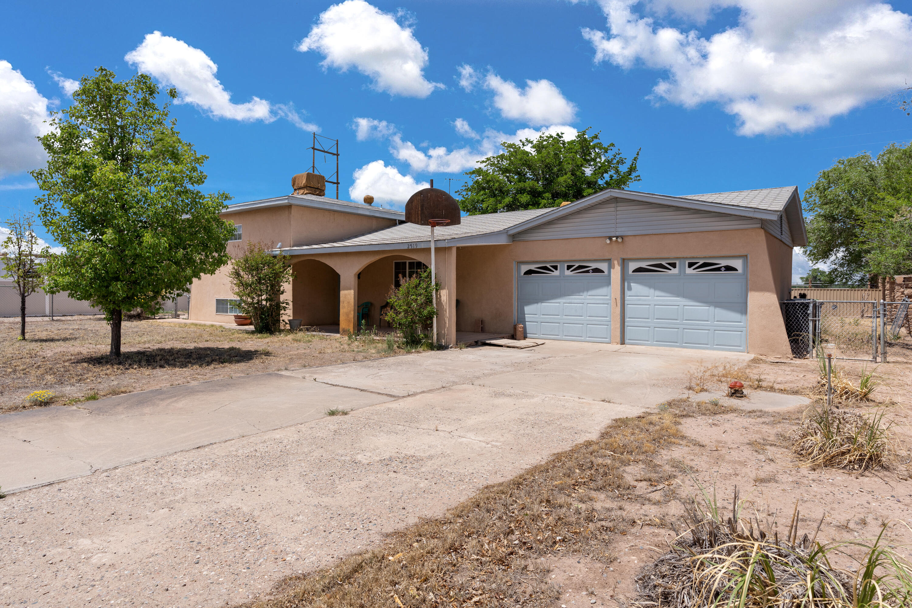 A touch of nostalgia in this country style South Valley charmer tucked away on a neighborhood cul-de-sac street!  Approx half acre lot with a gated entrance, fenced front yard, fenced backyard, mountain views, backyard access, large screened-in porch for gatherings of family & friends and room to make improvements for outdoor living spaces, pets to roam, recreation vehicles.  This 3BDR/2BA tri-level home features 3 large living areas; formal living rm, spacious family rm addition w/pellet stove & mini-split AC/Heat and cozy den with a wood burning fireplace.  Country kitchen has beautiful cabinetry, tile flooring & bkfst nook.  Primary bdr has 3/4 bat and two secondary bdrs share a full bath.  Separate utility room. Bring your imagination and ideas and make it your own!!