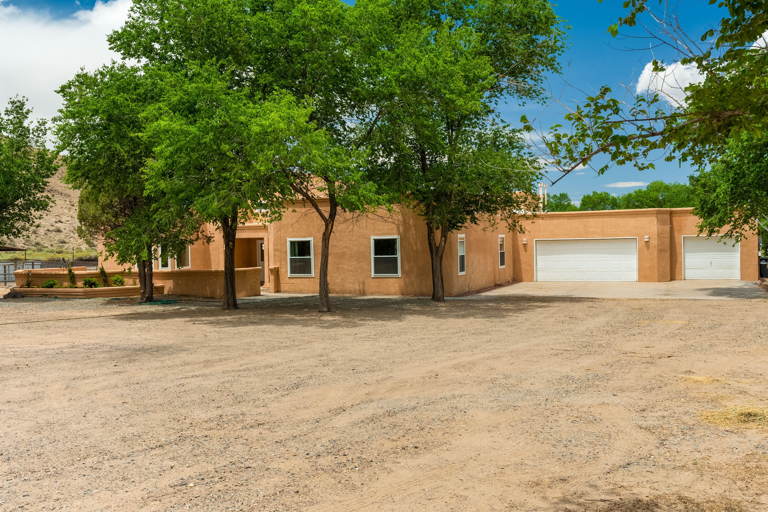 Bring all the animals & loved ones! Barn-36' x 36' with 4 12x12 stalls, hay and tack area, plus pasture w/cover , chicken coup and room to have other animals as well. Home owners have done many upgrades since purchase in 2020-including replacing the windows, water heater, furnace and AC, toilets, fixtures, some lighting, most appliances. Lovely courtyard entrance into this beautiful light-filled home with  raised ceilings.  Open floorplan, gorgeous clerestory and picture windows. Updated kitchen wi/ SS appliances, marble counters, and bar seating. Stunning owner's suite-sitting area, walk-in closet and access to back patio. Spa-like bathroom-free standing soaking tub, modern granite tiled separate shower & granite-topped vanity. Wood stove w/ blower for cozy nights. TPO roof in 2020.