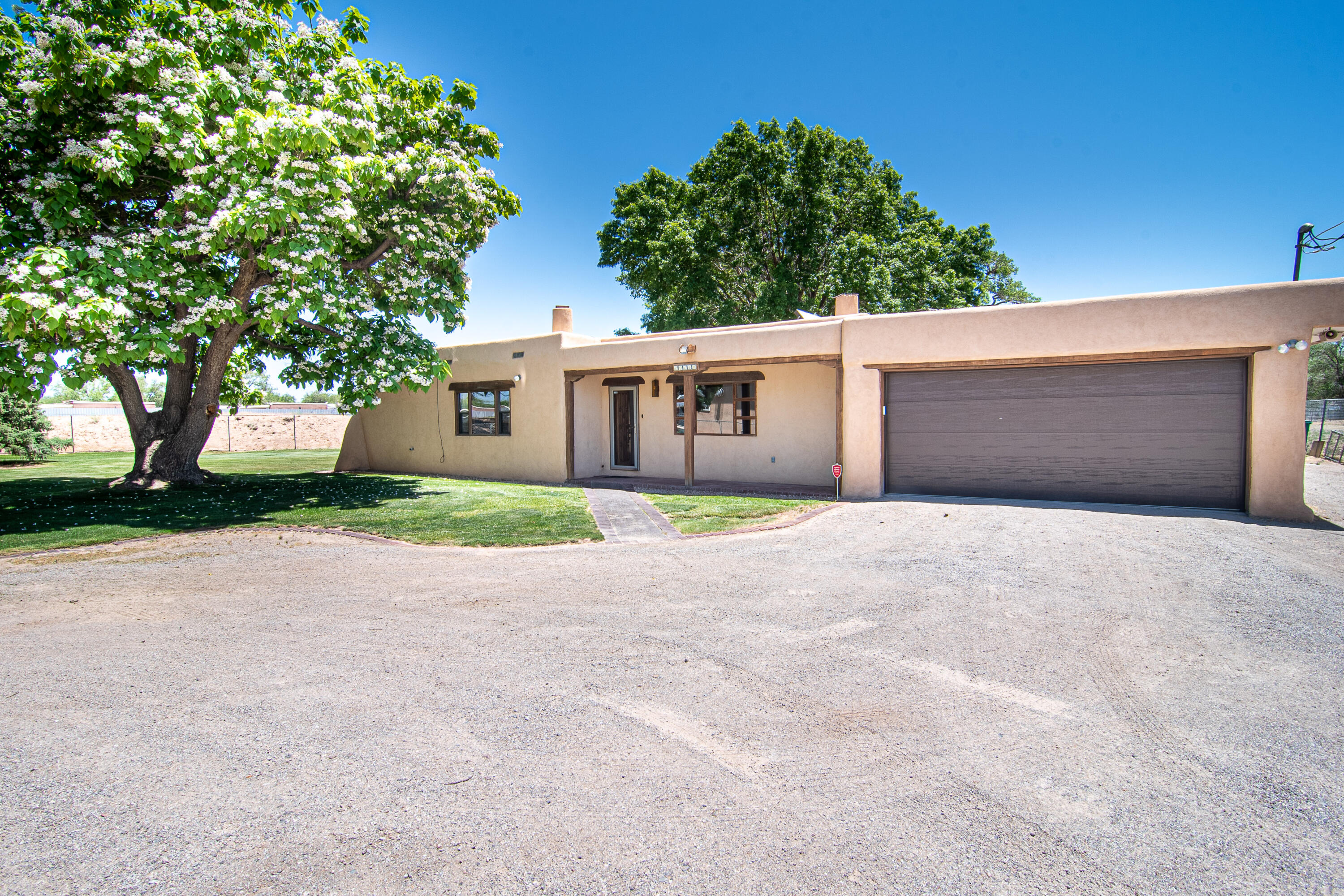 Beautiful Custom Northern New Mexico home located in the heart of the North Valley. Home sits on a .67-acre lot at the end of a private drive. Lush Lawn and Large Trees surround the home. Backyard has beautiful views of the Sandia Mountains and Balloon Fiesta Park. 2476 sq ft. 3bed/2full bath.