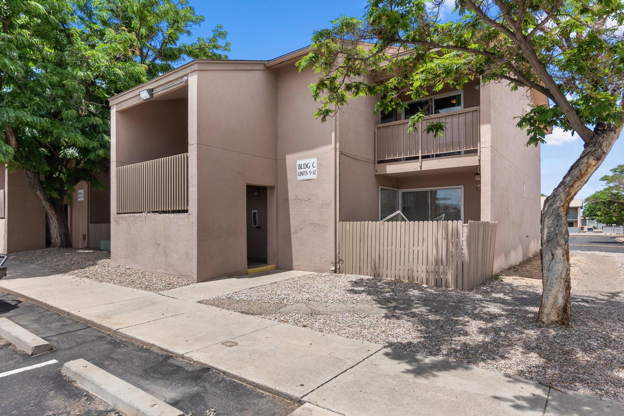 Updated Modern Condo in Carlisle Square Condominiums w/ Laundry in Unit! Stylish living in a great location near Montgomery and I-25. 2 bedrooms, 1 bath w/ 2 bath vanities in a lovely and livable floor-plan. Modern wood laminate flooring and stylish gray cabinets in the galley kitchen so cooking and entertaining are a breeze! Enjoy the walk-in closet in the larger bedroom, the light-filled dining space and soak up ABQ summer nights on your private balcony! Worry-free maintenance since the HOA covers exterior and common area!  Kids playground and green areas perfect for family enjoyment. The complex is next to the North Arroyo bike path so you are just a quick bike ride or car commute to UNM!
