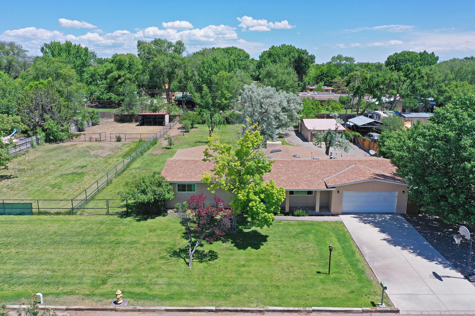 Beautiful North Valley home with over an acre of land, horse stables/barn/ and tack room.  Easy access for horse rides along the Bosque thanks to the irrigational canal rode just behind the house.  Enjoy mountain views, irrigation well to freely water all the manicured grass and trees , city water for the house. Upgrades include newer refrigerated air and furnace, synthetic stucco, hardwood floors and tile (no carpet), insulated mancave and garage, epoxied garage floors, large workshop, sunroom, newer kitchen appliances (2020), custom jetted tub and shower tile.  Backyard access from the side of the house and from horse trail behind the house. Enjoy country living in the city with easy access to Paseo, Alameda open space, and shopping.