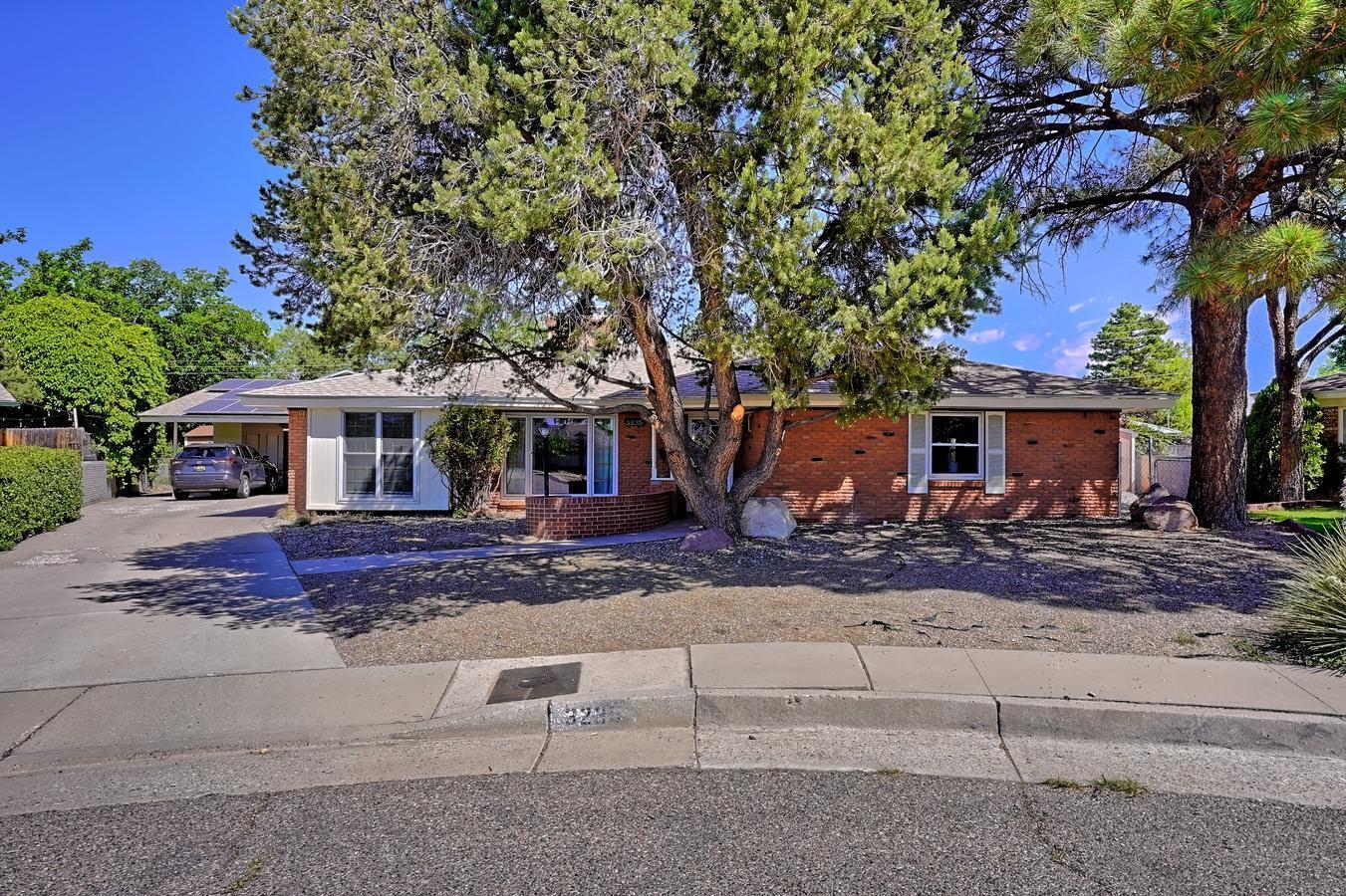 OPEN HOUSE SUNDAY 6/4 1:00-3:00 PM! Fabulous Upgraded and Updated Brick One Level Home! Ideally situated on oversized .27 of an acre Culdesac Lot! Sought after NE Heights/Eldorado High District! Dual Living Areas + Huge Game Room!Abundant Cabinets/Counter Space In the Updated Kitchen! Kitchen is open to Dining/Living Combo! French Doors From Living Beckon you to Enjoy your Outdoor Living Space! Large Covered and Open Patio + 2 sheds or a workshop! Perfect for Backyard BBQs! The Options are Endless to Create your own Flexible Use Space with Multiple Living and Dining Areas! Remodeled Owner's Suite is an Inviting  Haven Featuring Custom Bath with Decorator Tile! New Designer Lighting and Ceiling Fans! Refrigerated Air! ENERGY Efficient Solar! Currently NO Electric Bill, PNM pays the Owner!