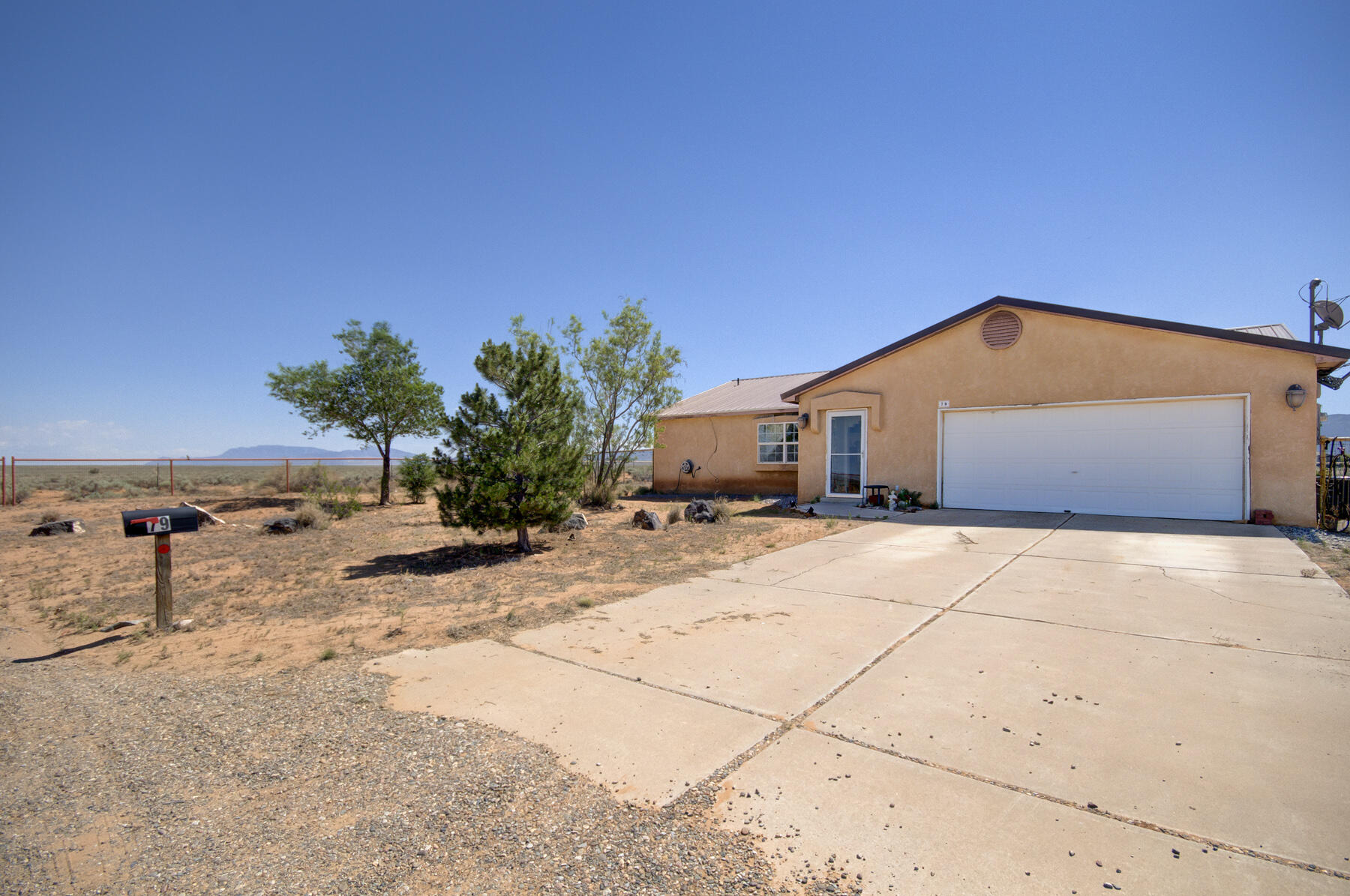 Welcome to this beautiful one story home with lovely curb appeal in the Los Lunas on a .77 acre lot. This home features an open floor plan with the kitchen looking into a wonderful living room with high ceilings and a fireplace. There are two guest bedrooms and a guest bathroom. REFRIGERATED AIR, METAL ROOF, and NATURAL GAS. The master bedroom has a walk-in shower.  The backdoor leads to the patio area where you can enjoy your little piece of paradise with the most AMAZING VIEWS!!