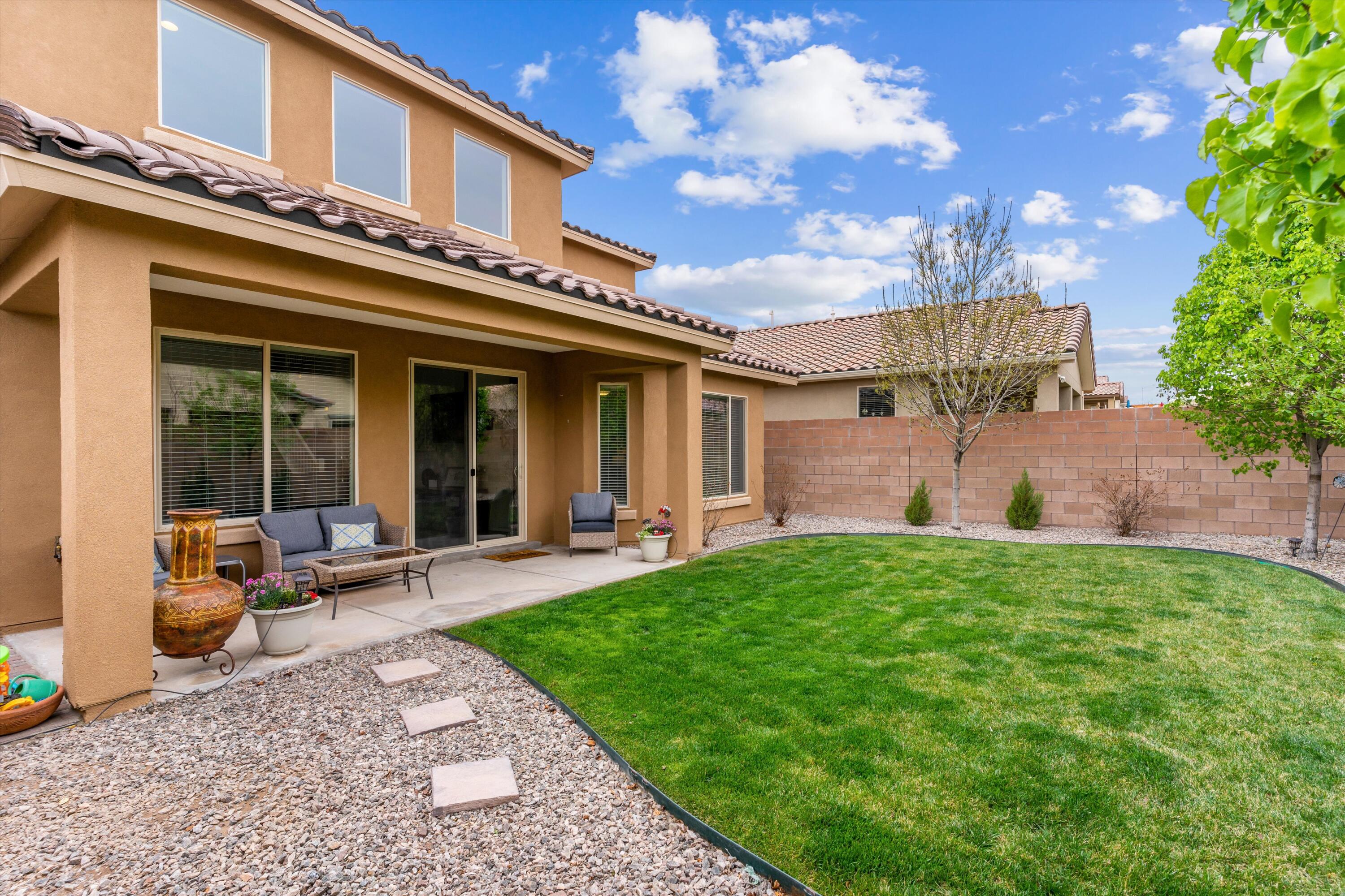 This beautiful two-story Pulte home features an open-concept floor plan with 4 bedrooms and 4 bathrooms with a kitchen that flows into a cafe area and large gathering room. Open kitchen with  granite counter tops, built-in stainless steel appliances, and tile back-splash. Staircase leads you to a loft that overlooks the gathering room that provides additional living space. The owner's suite on main floor features a private bathroom with double-vanities and a glass-enclosed shower. Other features include a Loft and a second master suite upstairs with a full bath, and cultured marble counters in the bathrooms. Backyard is complete with lush grass, trees and a covered patio.