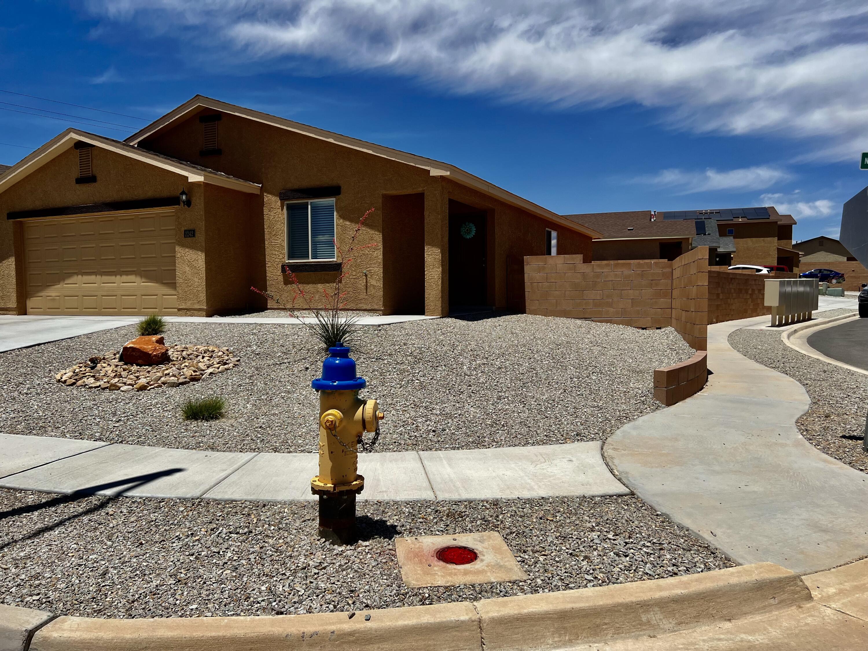 Don't miss out on this practically new GEM!!! Wonderful home in desirable neighborhood. Convenient to I-25, bedroom community to Abq. This 1-story, cozy home w/curb appeal, has SW landscaping in front on drip system w/timer, astro-turf & gravel in backyard. Impeccable stucco detailing. Covered porch leading to front door. 3 bed, 2 full bath, open concept space with living room flowing into a modern kitchen w/breakfast bar, upgraded appliances, large upper dark-wood cabinets, spacious granite countertops. From kitchen, sliding glass doors lead out into a fully walled-in backyard for privacy. Other features include double-pane, Low-E Vinyl windows, service room w/washer/dryer & door to attached 2-car garage. Corner lot. Come see for yourself!