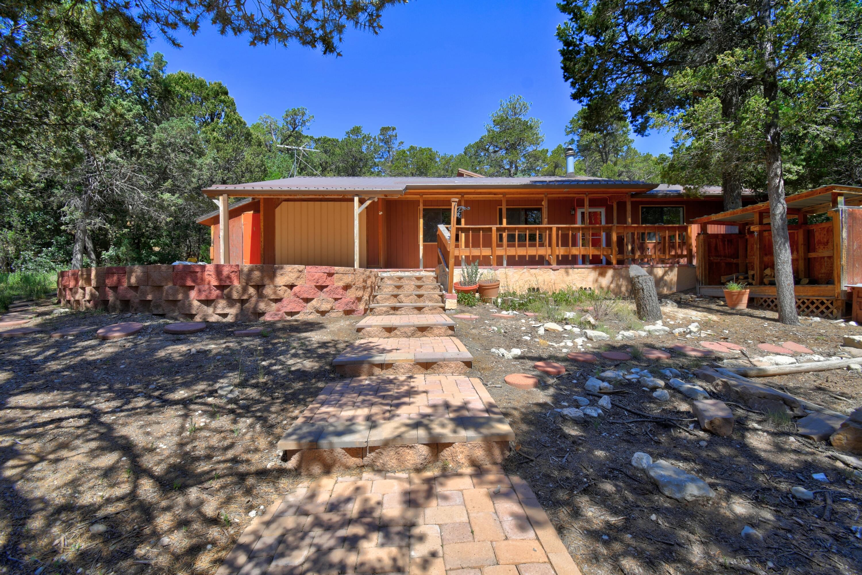 Escape the city and find solitude amid the staggering ponderosa where the starry nights dazzle and adventure begins. Tucked away in Skyland Subdivision and within walking distance of Cibola National Forest and Mars Court Trailhead, you'll fall in love with the peace and quiet this unique property has to offer. Prepare to be impressed by the advanced UV filtered, 9,000 gallon water haul system putting to rest the worry of a well going dry. This system is additionally supplemented by a seamless gutter system that feeds into the anti-algae tanks. Schedule your showing today before it is too late!
