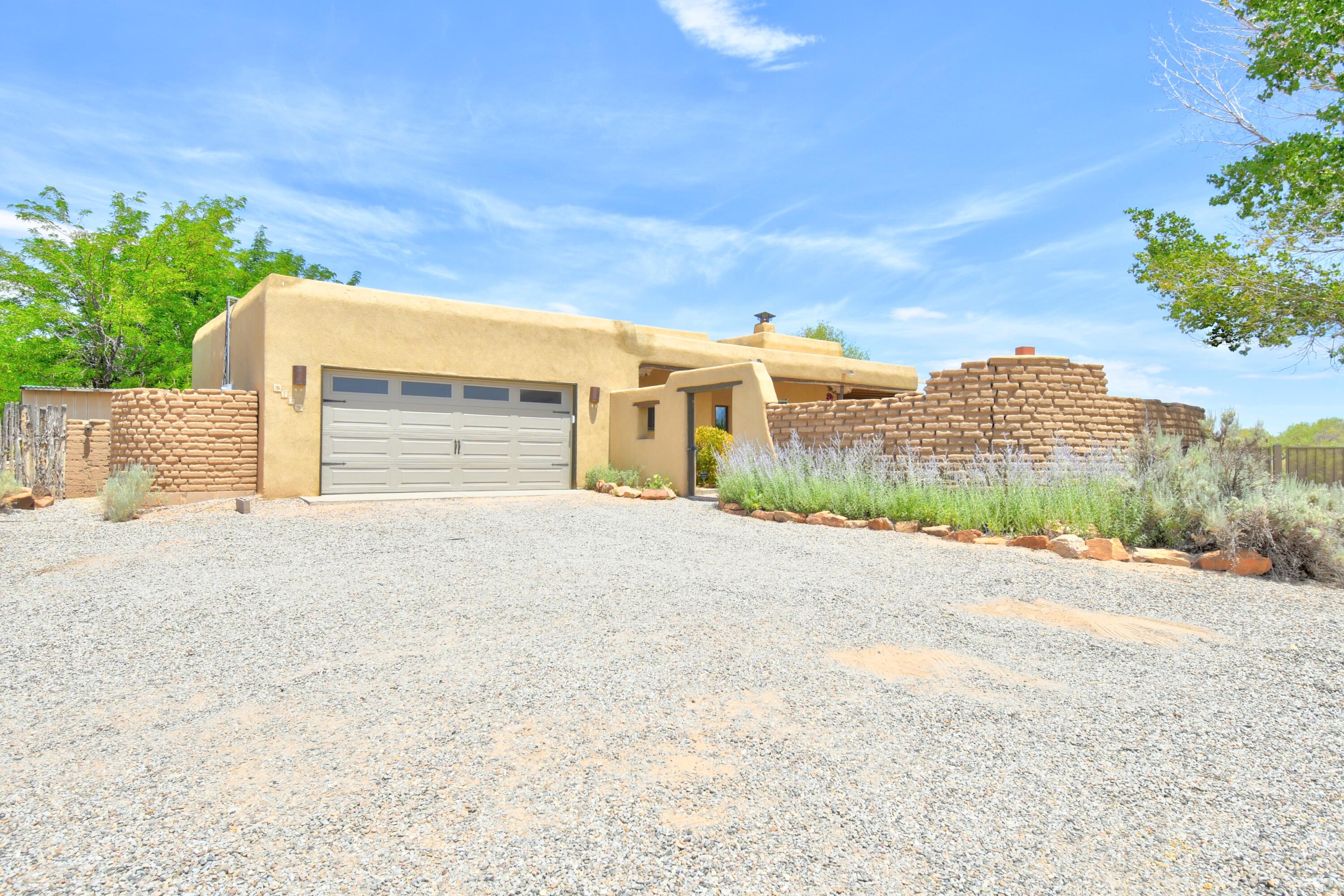 Tranquil Corrales Living w/5 covered patios and picturesque Mountain Views from BR, LR & Den! Huge brick entry patio with traditional Bankos, Kiva , Adobe bricks AND killer views-perfect for outdoor gatherings. XL 545sf garage w/utility sink. Radiant heat, recent Kitchen remodel, Quartz Counters, gas range, touch-less faucet, SPECIAL EYE LEVEL PANTRY, more efficient WIFI, salt-less water softener, and Vinyl Flooring bring your living  level up! Gaco Silicone Roof Aug '21-w/10 yr warranty. 1 year transferable home warranty in place. Outside garden beds, trees, grass, horse corral,storage unit, hot tub pad and additional brick patio w/bankos & Adobe walls brand this home Corrales!  Inspections and repairs completed for YOU! Baby Grand and Marlin would love to STAY! Come take a look today!