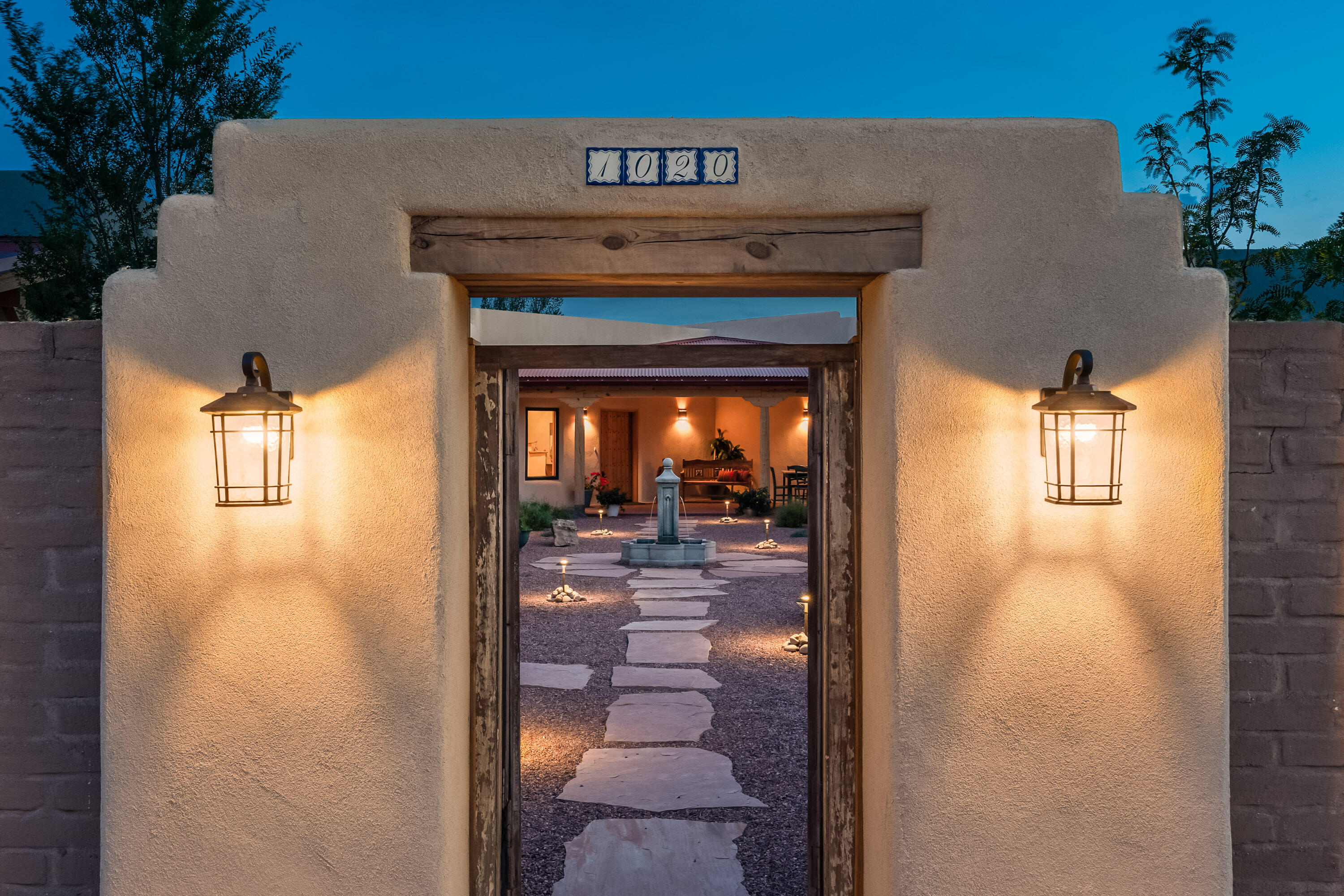 Lovely, newly built Los Ranchos Adobe situated on 1/2 acre.An easy living 3 or 4 bedroom home, one level, no steps, with an outstanding kitchen with custom tile work, Wolf range. Superb outdoor living spaces with brick portals, ceiling fans, and wonderful entertaining spaces. An attached casita provides separate living quarters, complete with lovely tiled  kitchenette, and full bath. In the main house, one bedroom is ideal for an office, with separate entrance, parking, & bath. The other bedrooms all have ensuite baths and generous closet space. The outdoor gardens have drip irrigation and can be as lush as you desire or stay easy care. Oversized 3 car garage provides ample parking and workshop space. Walking trails nearby. Come Visit this charming home and make it your own!