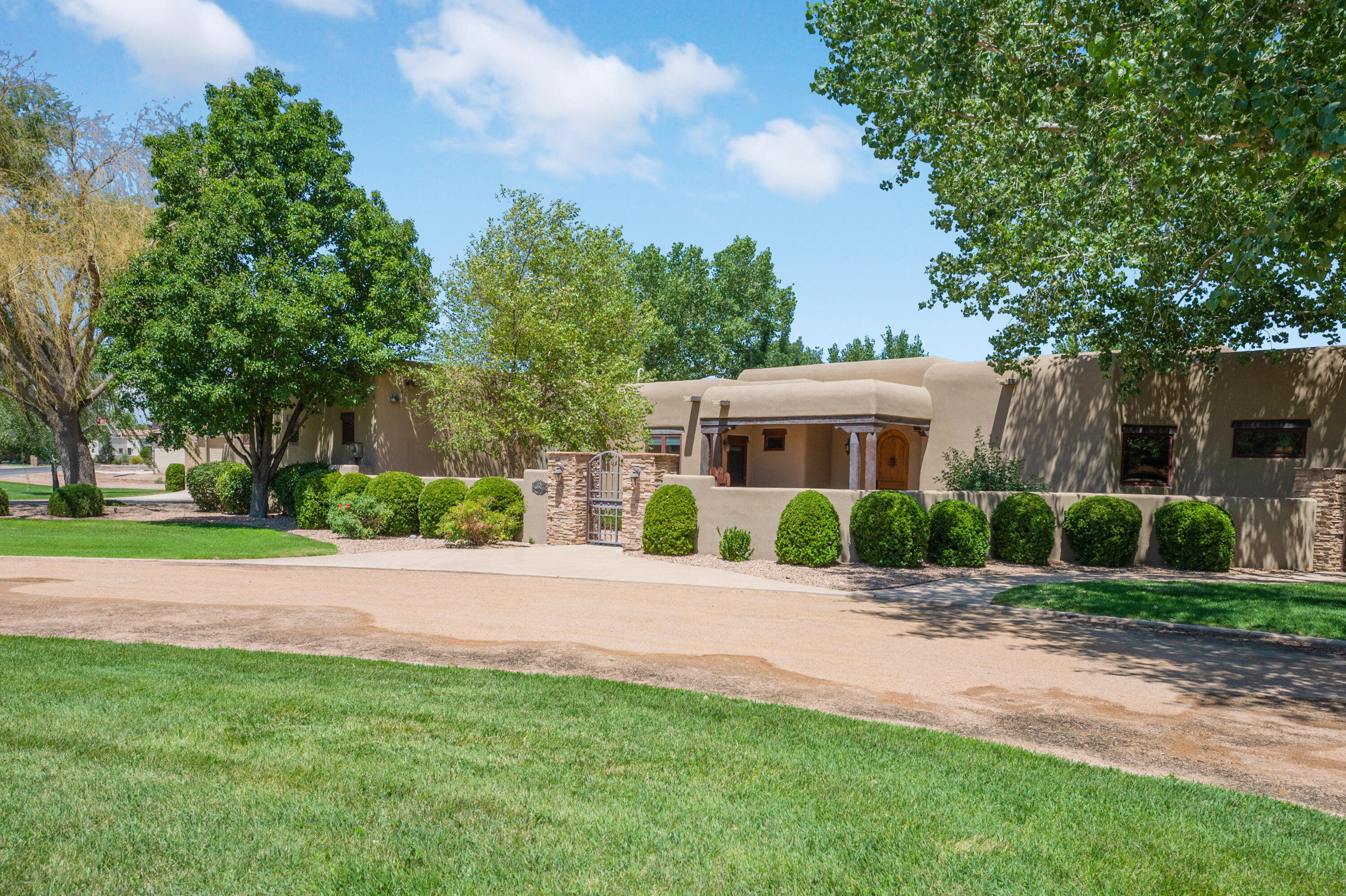 High Demand gated Bona Terra: upscale homes & best location!  Award winning builder David Waszak crafted this gorgeous New Mexico style w special touches like Four Kiva Fireplaces- gas log, Wood beam ceilings, wood clad windows, diamond plaster walls, ''corbels and niches''.  Luxury living with Wolf 5 burner Gas range, 2 ovens, Subzero Frig & Freezer, Wine Frig, 2 covered Patios, +Portico.  Covered Outdoor Kitchen: built-in Wolf grill, sink & frig.  Private primary suite w  TWO walk-in closets, (Owners added it!), 2 sinks, tub, great shower w 3 shower heads.  Large Media Room w Wet Bar- cud be a 5th bdr.  EXTRA 3car garage w Bath- could even be future guest quarters??  The sellers paid prior for blueprints to convert garage & will provide the plans! Lush green oasis w Irrigation Well!