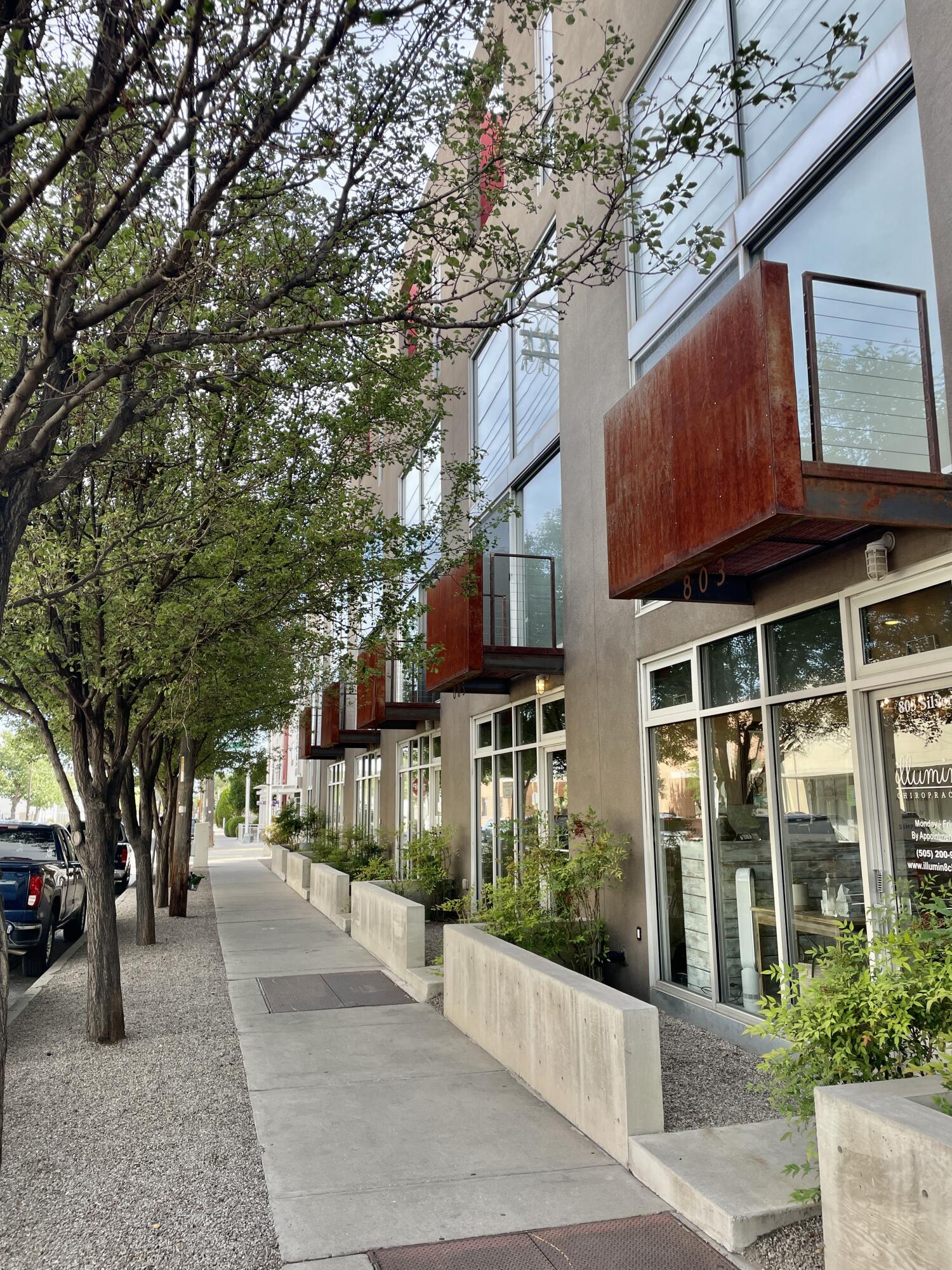 Enjoy downtown's skyline & the Sandia mountains from this posh modern 4-floor loft in the premier phase of the award winning Silver Lofts. Elegantly designed w/bamboo floors; diamond plate open metal stairs; white caesar stone counter tops w/espresso cabinets; 17ft floor-to-ceiling glass w/automated blinds in main area.  Entire 4th floor houses primary bedroom suite featuring 9'5 x 6'6 exterior balcony; 11'6 x 8'4 walk-in closet; and 12'3 x 11'8 bathroom w/ walk-in shower, soaking tub & water closet. Located on the border of Downtown (ABQCore) & Raynolds neighborhood, enjoy best of both... close to restaurants; farmer's market; zoo; train; art galleries... distanced from Downtown's music scene. Dual zoned (ideal  for home &/or office space). Plus an attached 2-car garage w/ gated driveway