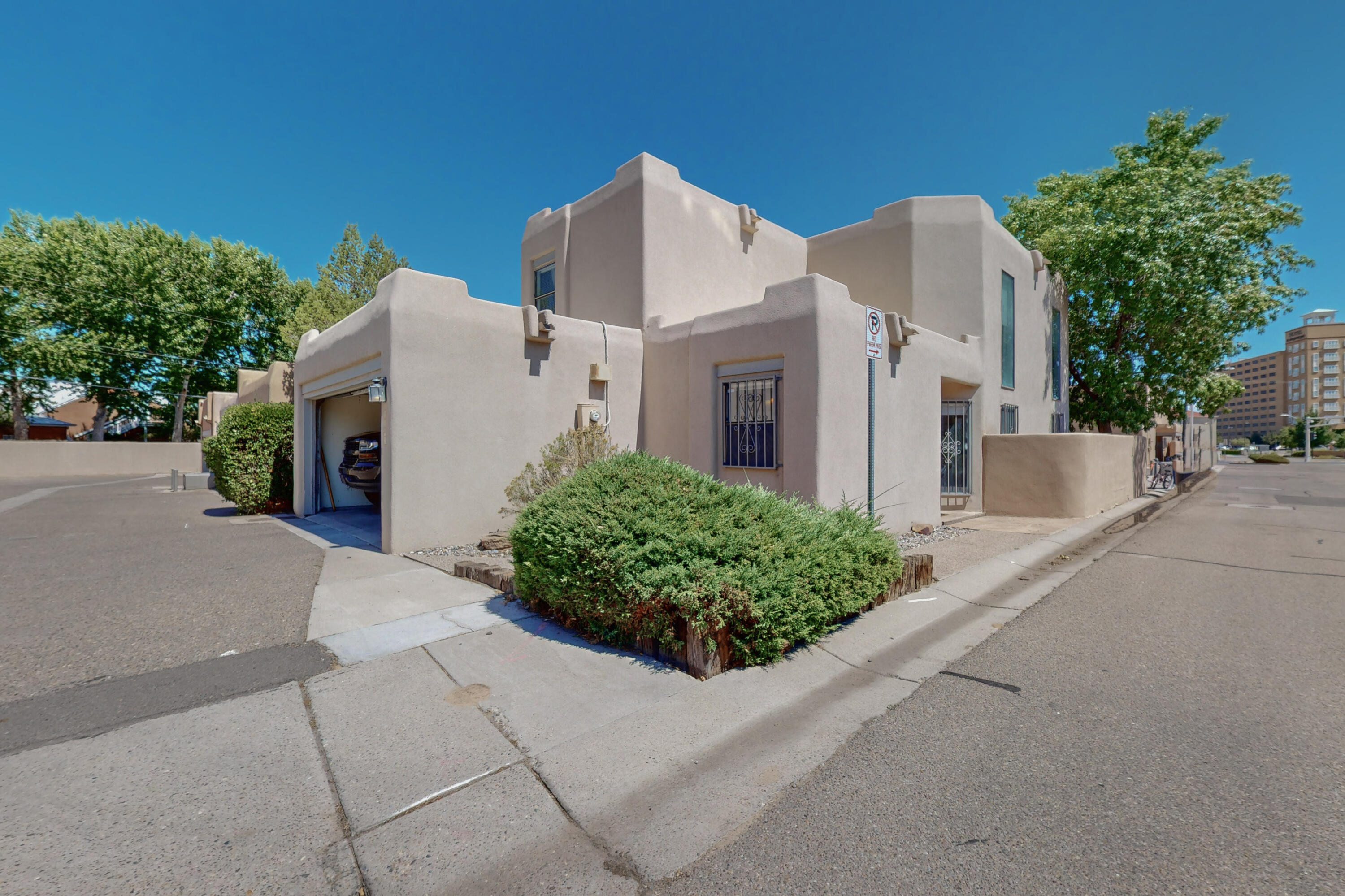 Updated northern New Mexico style town home in our fantastic Sawmill neighborhood. Breathtaking two level floor plan offers two fantastic living areas, large & private bedrooms, stylish formal dining area, & an easy, eat-in kitchen with stainless appliances and granite counter tops. Nichios, vigas, wooden shutters, and soaring wood ceilings. Huge loft area includes a wet bar. Main floor master suite includes a custom, large garden tub, separate shower, & double vanity. Outside, you'll enjoy a beautiful, relaxing balcony space and a private courtyard. Walk to Old Town, all the best restaurants, & museums, with very easy access to I-40 & downtown & hiking & biking trails. Refrigerated air. This gorgeous corner lot townhome has it all.