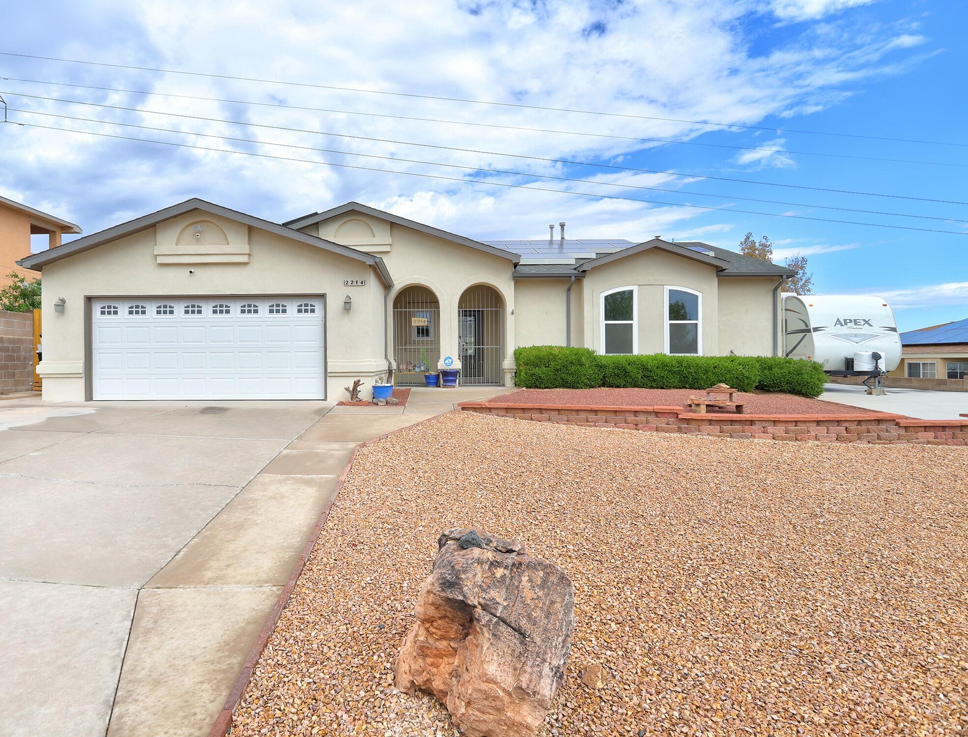 Put this home on your MUST SEE LIST! Recent upgrades include: RV Pad w/ 30 amp outlet; vinyl replacement windows, xeriscaped yard, 2 yr old washer/dryer/SS dishwasher. Other updating: Roof was replaced in 2015, stucco redone in 2016, AC unit replaced in 2021, kitchn & baths are modeled too. Extensive work completed in front & backyards; xeriscaping, install of pet turf,  bee/butterfly garden, wall height increased, side yard wall+ gate installation & more.  Storage shed discreetly placed in back yard.  Large patio area with hot tub & retracable awning. Energy savings due to solar panels. Ave. monthly payment to SunRUn is $95+$8 for PNM.  Can't beat those energy costs! Home is clean and ready to go!  Just unpack and ENJOY!