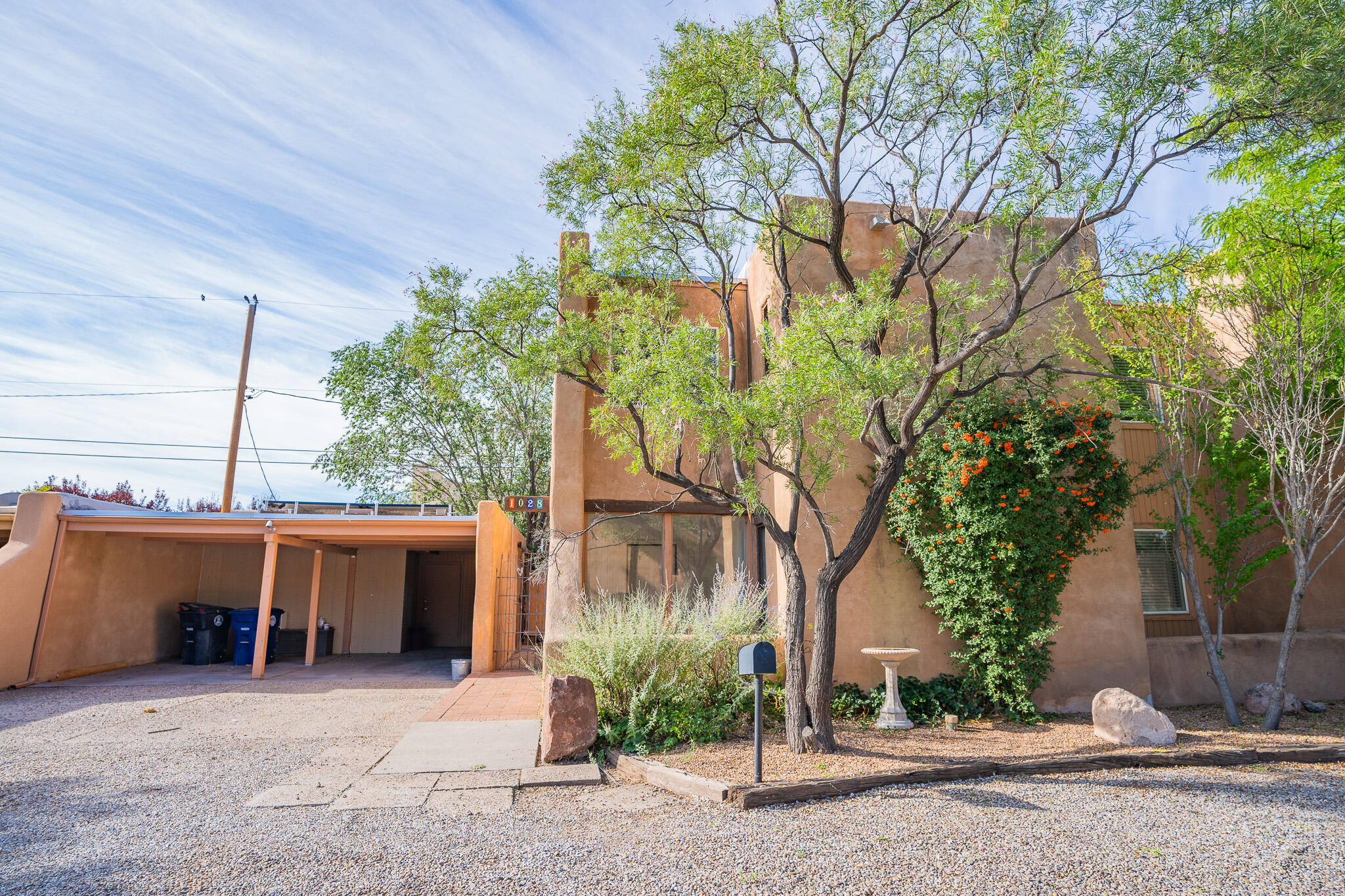 Indulge in enchanting Southwestern ambiance in this meticulously crafted Marilyn-built townhome! Featuring exposed adobe walls, rustic brick floors, captivating beamed ceilings,  a cozy kiva fireplace, and brand new roof (2023) this home exudes undeniable charm. Step through the welcoming saltillo tiled entry, be drawn into the spacious living & dining area, ideal for both intimate gatherings & large get-togethers. Adjoining sunroom offers a tranquil retreat w/ courtyard views, perfect for relaxing while soaking up the New Mexico sun. This is more than just a residence; it's a living testament to the cultural richness & architectural heritage of the SW by seamlessly marrying tradition w/ modern comfort. HOA covers common areas, landscaping, water, trash, & sewer, pool! Come see it today!