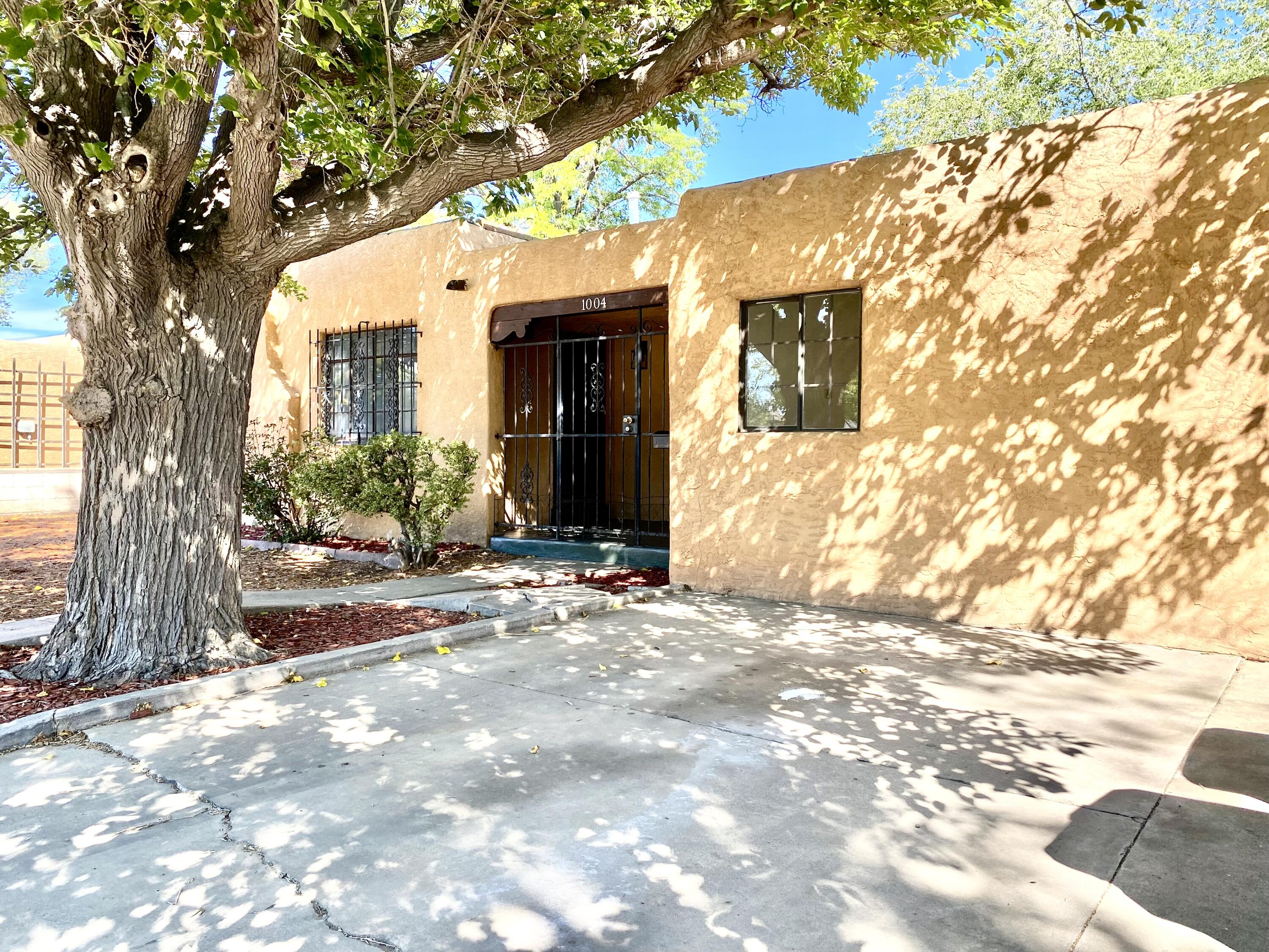 Near UNM Law and Medical Schools, parks within walking distance, minutes from downtown or uptown. This 4-bedroom home has stunning hardwood floors, a contemporary fireplace for those chilly nights, updated kitchen and bathrooms, new lighting and plumbing fixtures.  The bedrooms are spacious. The Kitchen features plenty of cabinet and countertop space. Sit in the oversized covered front patio to watch the sunset or sit in the shaded back yard covered patio. Large walled back yard with privacy is perfect for a pet.