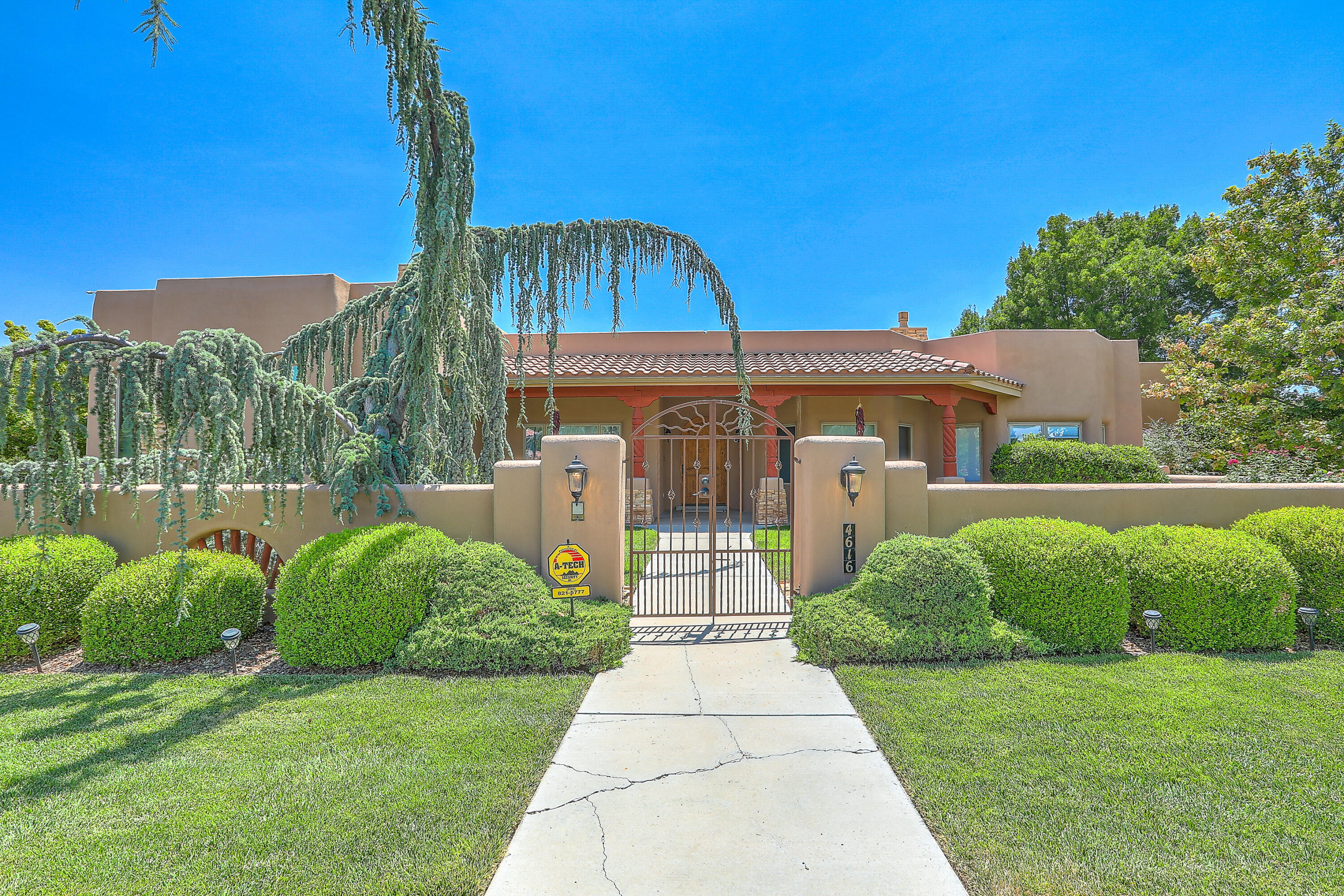 Open House 1-3pm Sunday!  Los Poblanos  single story home offers a lifestyle of luxury, comfort and elegance.  Located in the gated community of Los Poblanos Orchards on 1.21 acres in the NV. This property features a chef's kitchen with custom cabinetry throughout.  Generous primary suite with spa inspired bath and large closet. Refrigerated air, recently added makes you comfortable year around. Radiant and central heat make it cozy for the upcoming cooler mornings. Entertain on the large patio with wood burning kiva fireplace or keep it your secluded secret.  Beautiful salt water swimming pool/spa with water features and fire pits is dramatic and relaxing. Expansive lush grass grounds with trees and an irrigation well for backyard watering.