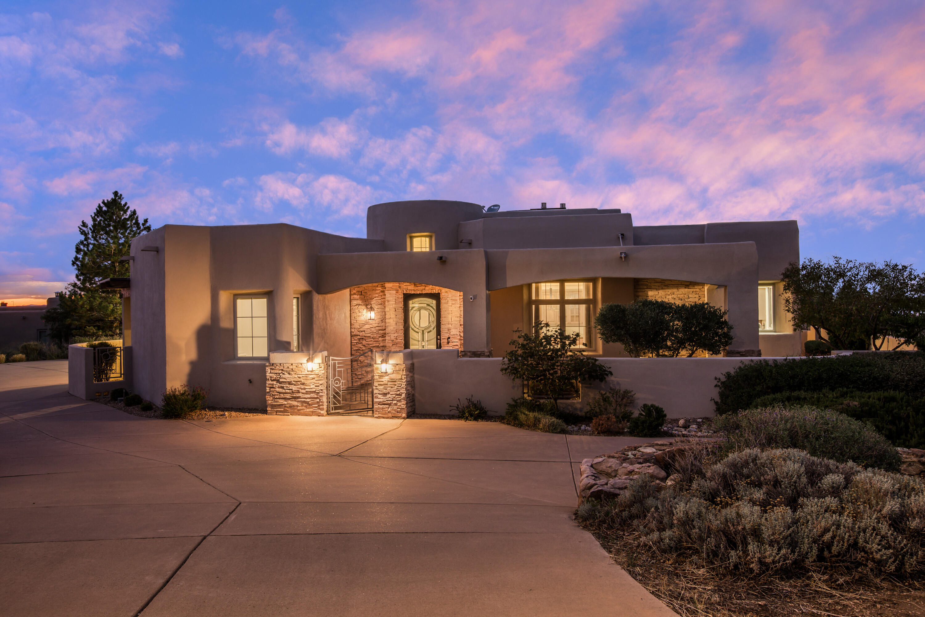 This incredible High Desert home was beautifully positioned on a cul-de-sac lot to take advantage of the views in all directions. Enjoy the beauty of the Sandia Mountains and the city lights of Albuquerque from within the home, as well as numerous outdoor patios and courtyards. This home features a bright and open floor plan with fresh white paint and updated light fixtures, offering a clean and modern aesthetic. Beautiful finishes include custom handcrafted cabinetry, stainless steel appliances, rich granite countertops, wood beams, and exterior stacked stone. Each bedroom offers an en-suite bathroom and a walk in closet. Multiple living and dining areas offer flexibility. Enjoy the convenience of this great location with access to shopping, dining, entertainment and services nearby.