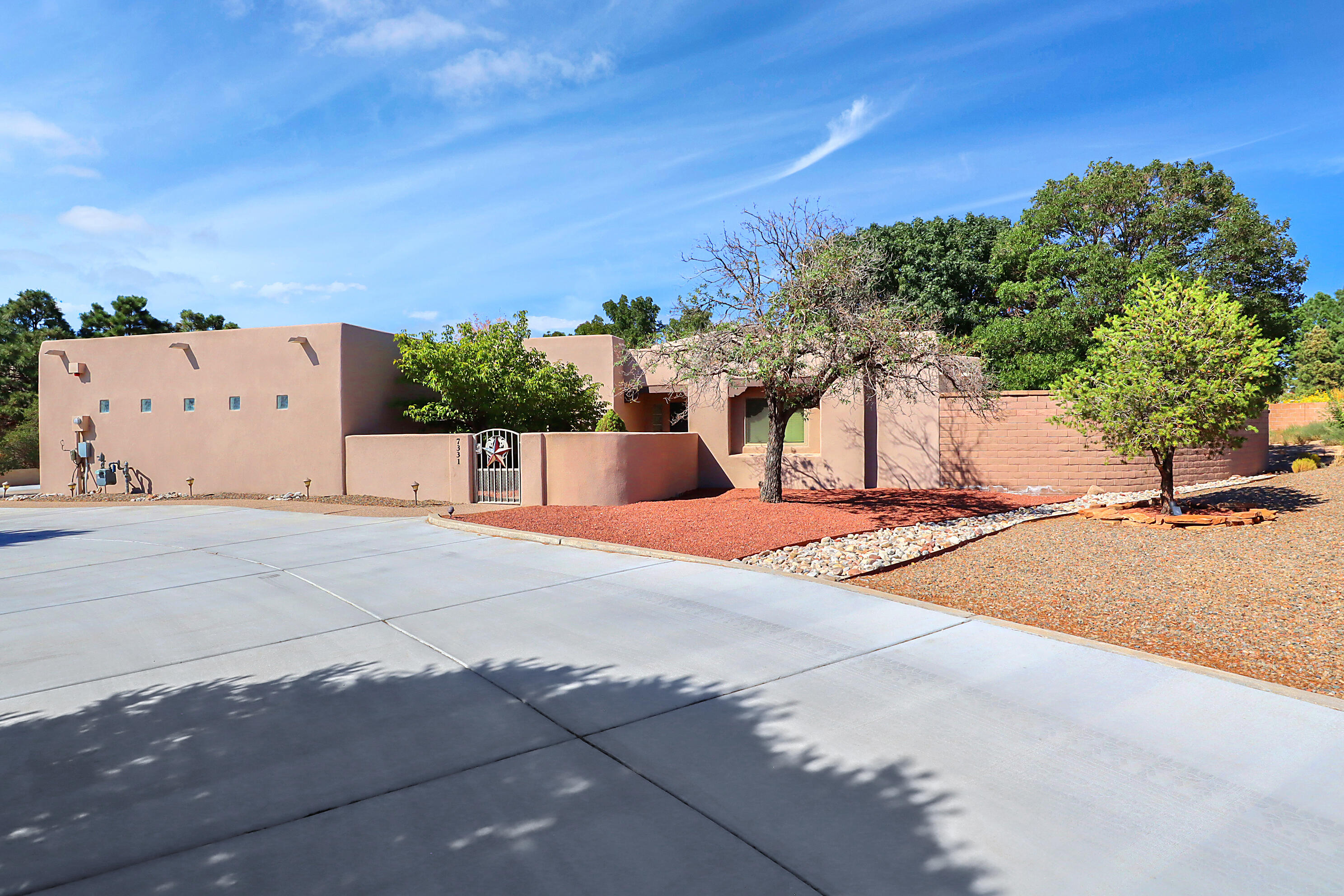This stunning single-level custom home with heated pool sits on a .89 acre lot in North Albuquerque Acres West.  At 2607 sq ft, this cozy home features 3 bedrooms, 2.5 baths, 3 car garage, and a fabulous office with custom built in book shelves.  The lush backyard oasis includes a covered patio, swimming pool, hot tub, gas grille, and fire-pit sitting under jaw-dropping views of the Sandia Mountains!  Oversized circular driveway and extended parking provide room for several vehicles, RV or other fun toys.  This property is on a septic and shared well.  You cannot fully appreciate the amazing backyard and views unless you see it in person.  Schedule a viewing today!!!