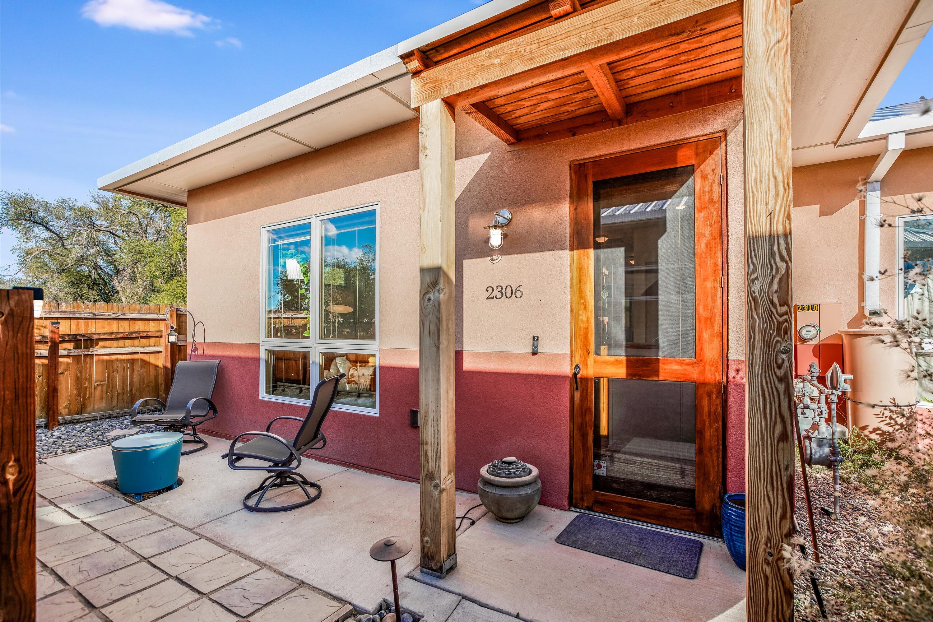 You don't want to miss this thoughtfully planned out townhome in the Acequia Jardin Co-Housing Community! Enjoy downtime in the open living space, combined kitchen & breakfast nook. Gorgeous wood floors, 10-ft ceilings & Pella windows give a luxury feel to this well-appointed home. Walls are thick, plus owned solar that's hidden away on the metal roof, keeping utility bills low. Main bedroom & office (or 2nd bedroom) at the back of the home--perfect for enjoying the peace & quiet, not to mention volumes of natural light! Continue out back to relax on your own private patio surrounded by natural beauty. Some of the many incredible amenities in this community include a guest casita with kitchenette, outdoor plaza, storage, group meeting room & community gardens all for a reasonable HOA fee!