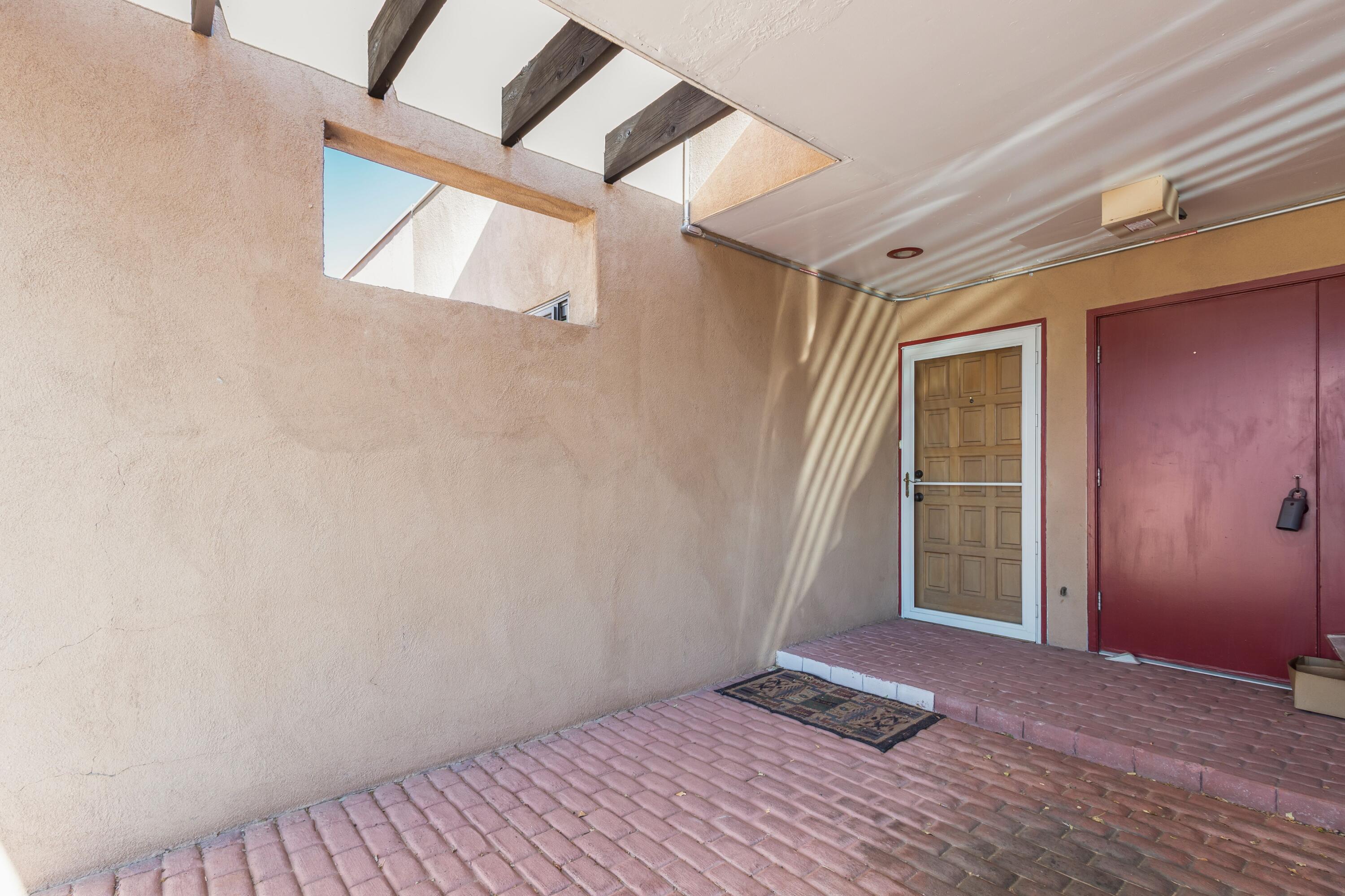 This lovely townhome comprises two bedrooms and one bathroom. It is located near North Valley and boasts a well-maintained exterior and interior. Convenient access to I-25 and I-40 makes commuting easy. It is just a five-minute drive from Downtown and a ten-minute drive from Old Town/Sawmill and Bio-Park. The main living area has laminate flooring, while the bedrooms are carpeted. The newer appliances and new water heater are bonuses. The home also features solar power, a pellet stove, a TPO roof, refrigerated air, and granite countertops in the kitchen and bathroom.  Front court yard and a loft in the prime bedroom. You will find two storage areas, one at the back and another storeroom at the front.